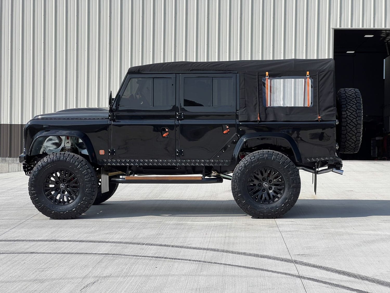 Side View: Custom Land Rover Defender Custom black Land Rover Defender with modified features