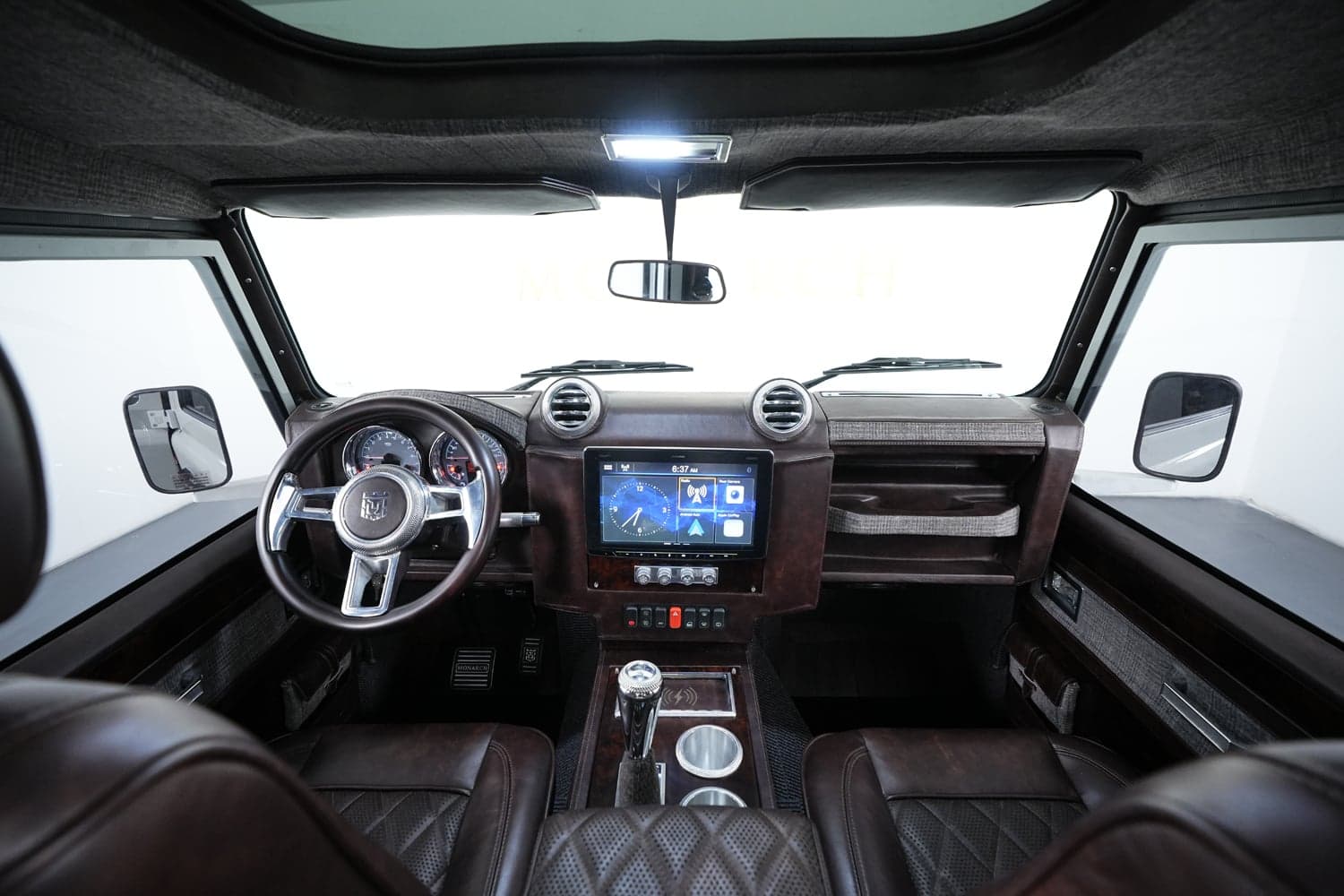 Interior Shot: Bespoke Cabin Design Luxury Land Rover Defender interior featuring leather seats and modern dashboard