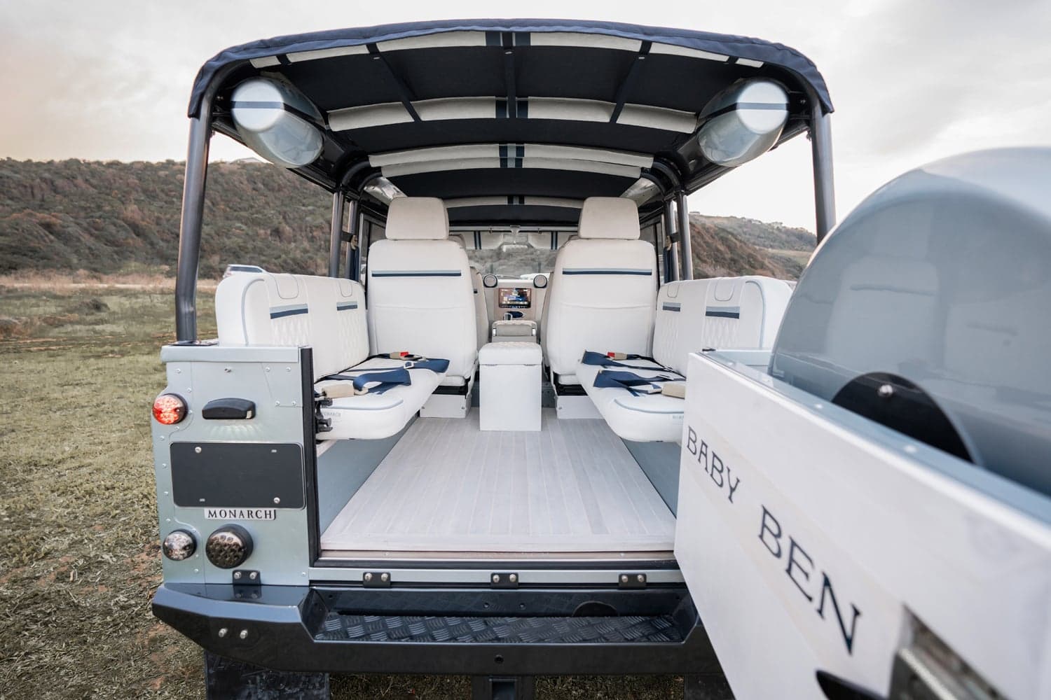 Interior Shot: Luxury Seating Interior of a custom Land Rover Defender featuring luxury white seating and modern design elements