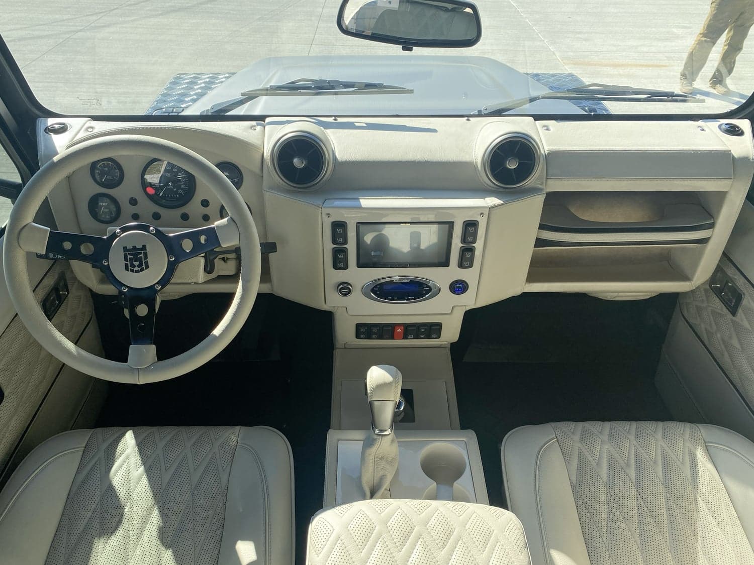 Interior Shot: Luxury Cabin Luxurious interior view of a custom Land Rover Defender, featuring a stylish dashboard and leather seats