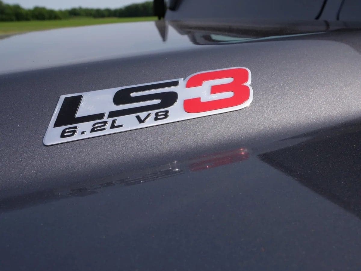 Close-up: LS3 V8 Engine Badge Close-up of LS3 6.2L V8 engine badge on a custom Land Rover Defender