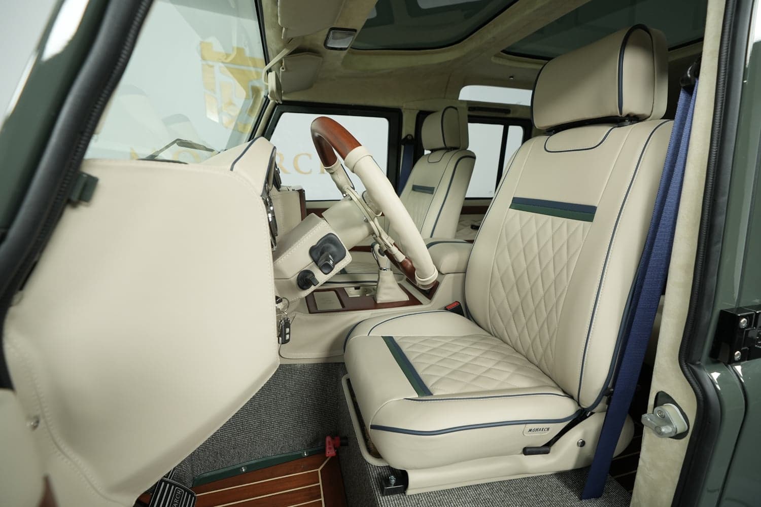 Interior Shot: Luxury Cabin Bespoke Land Rover Defender interior featuring premium leather seats and wooden accents