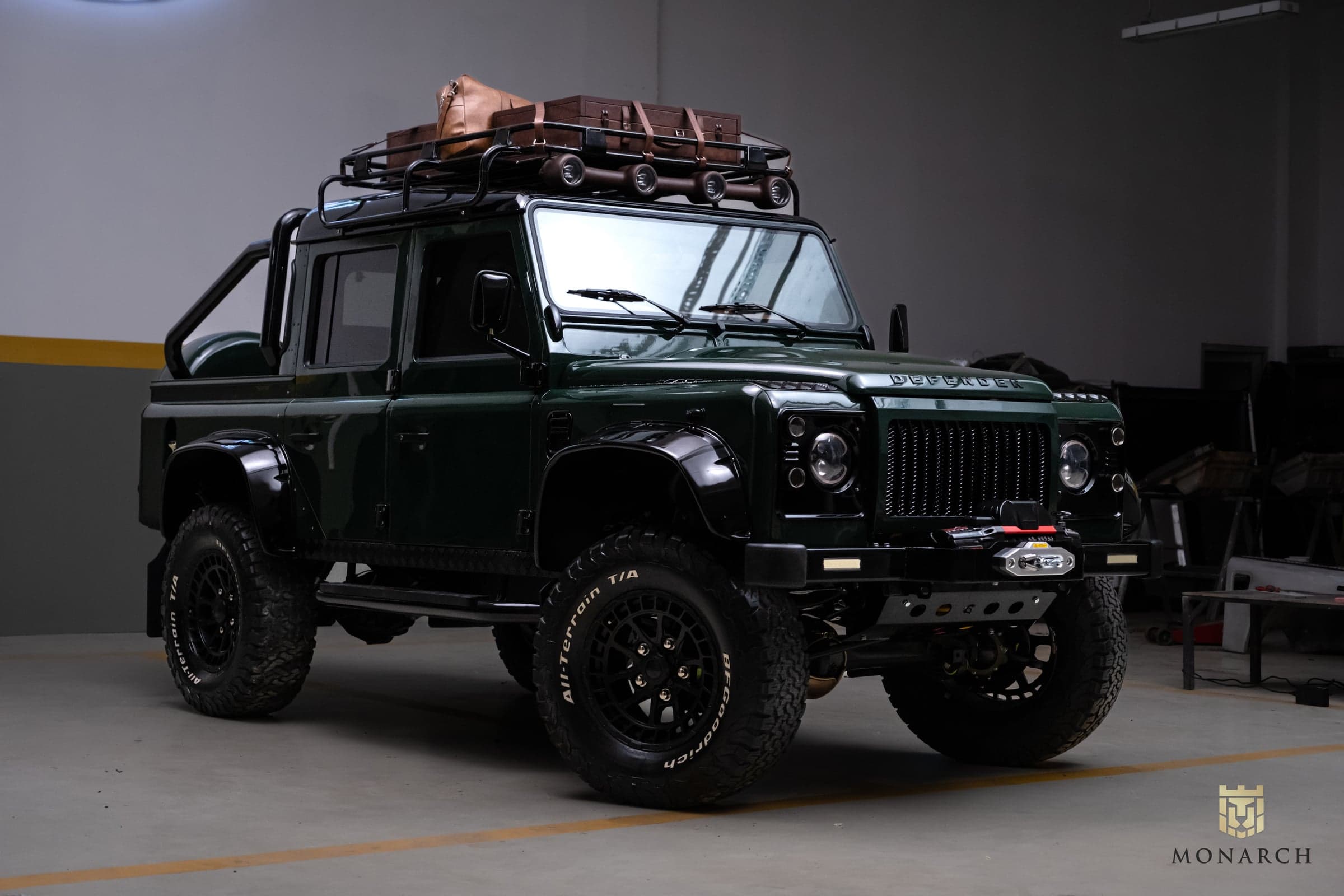 Studio Photo: Custom Land Rover Defender Bespoke green Land Rover Defender with roof rack and luggage