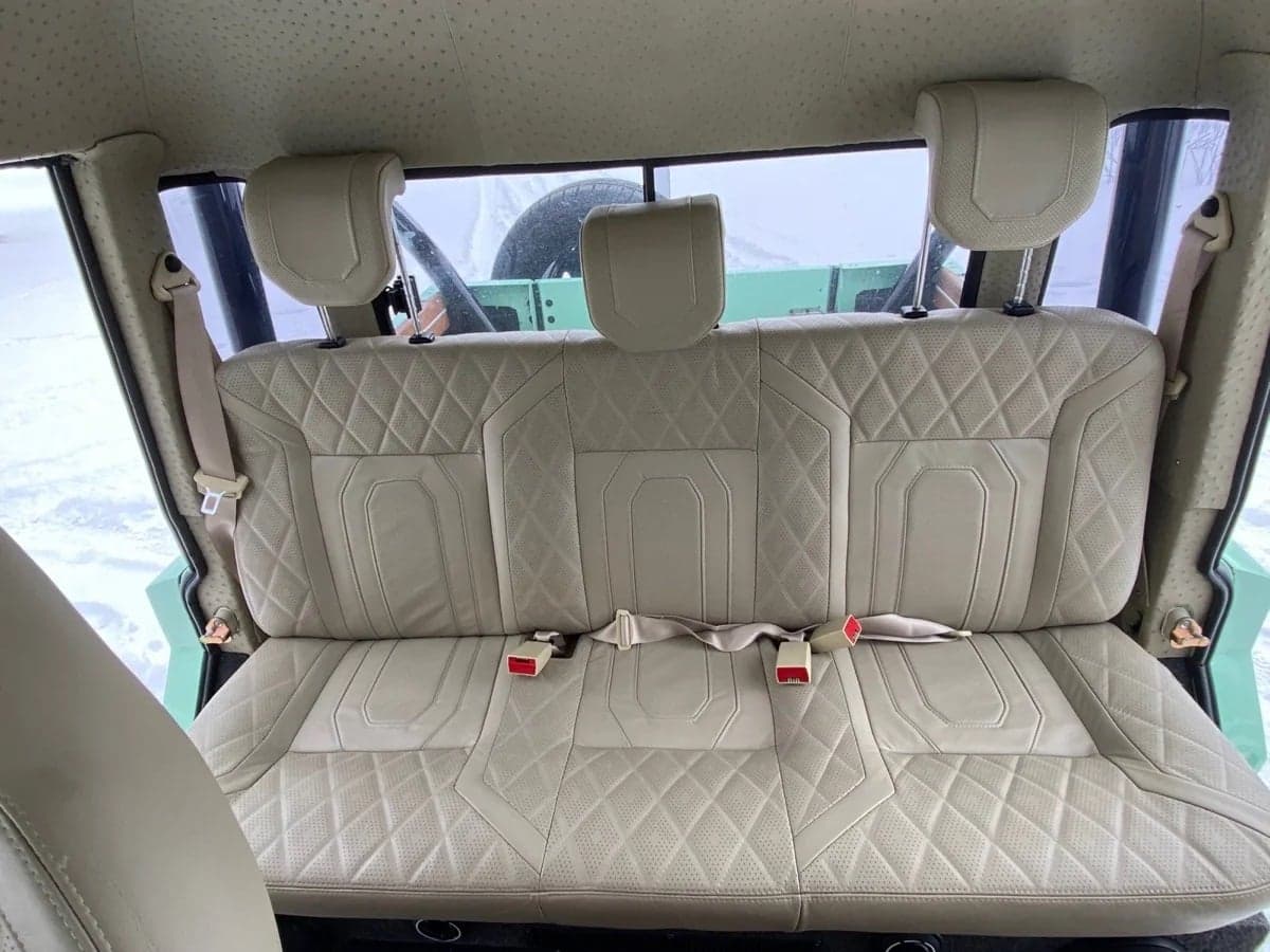 Interior Shot: Luxury Backseat Luxurious beige quilted backseat in a custom Land Rover Defender