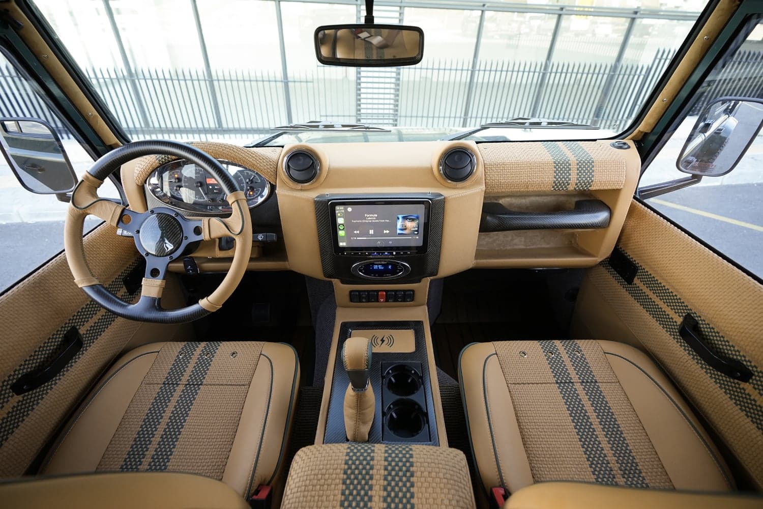 Interior Shot: Luxury Cabin Design Interior view of a bespoke Land Rover Defender featuring premium materials and modern technology