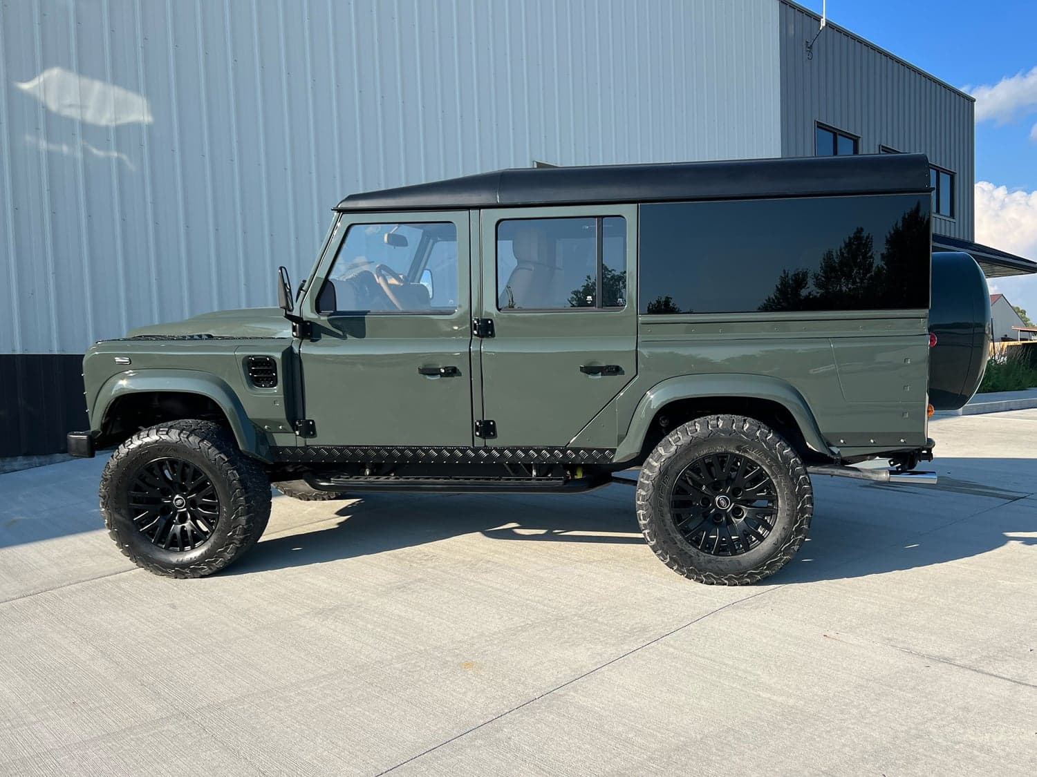 Side View: Bespoke Land Rover Defender Custom Land Rover Defender in military green with black accents