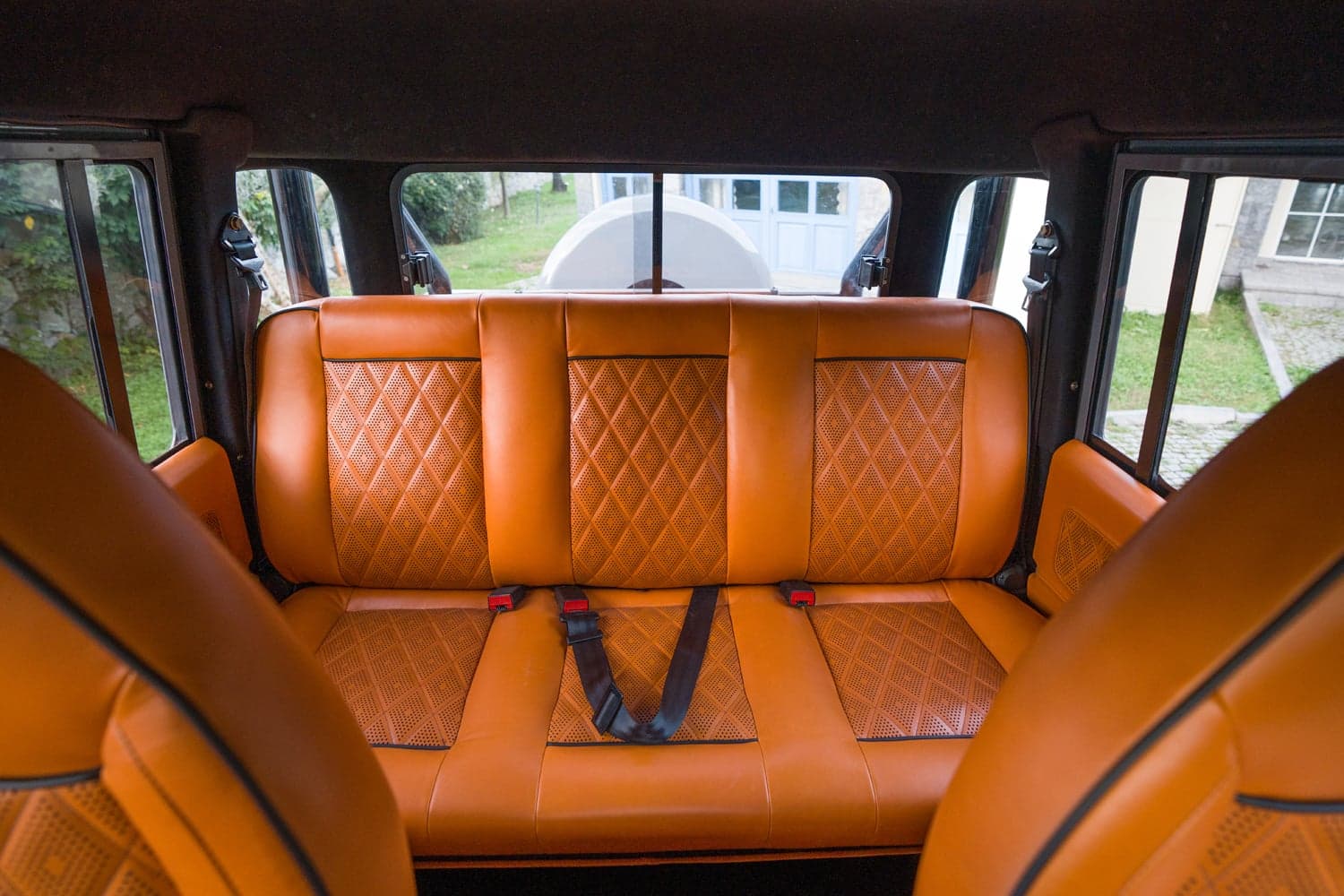 Interior Shot: Luxurious Rear Seating Custom Land Rover Defender rear seating in rich orange leather