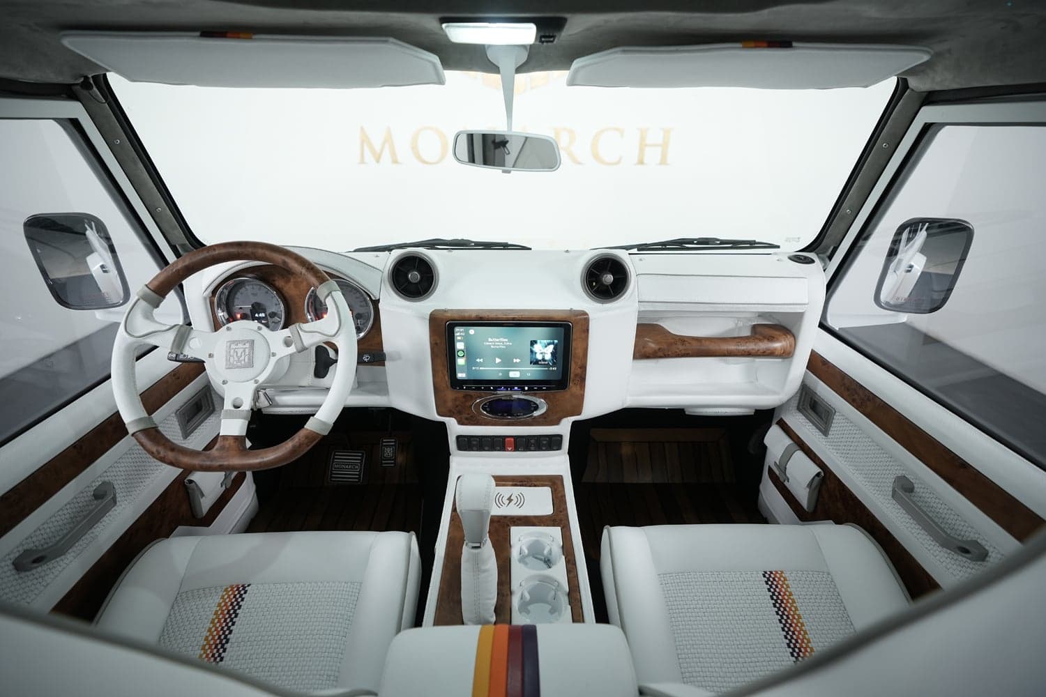 Interior Shot: Luxury Cabin Design Bespoke interior of a custom Land Rover Defender featuring white leather seats and wood accents