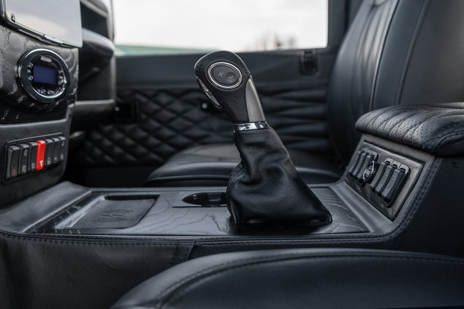 Interior Shot: Custom Gear Shift Interior view of a bespoke Land Rover Defender featuring a custom gear shift in black leather