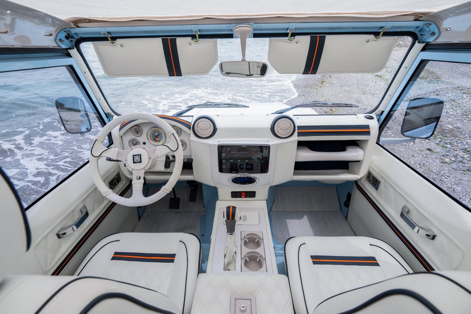 Interior Shot: Luxury Cabin Interior view of a bespoke Land Rover Defender showcasing premium leather seats and modern dashboard