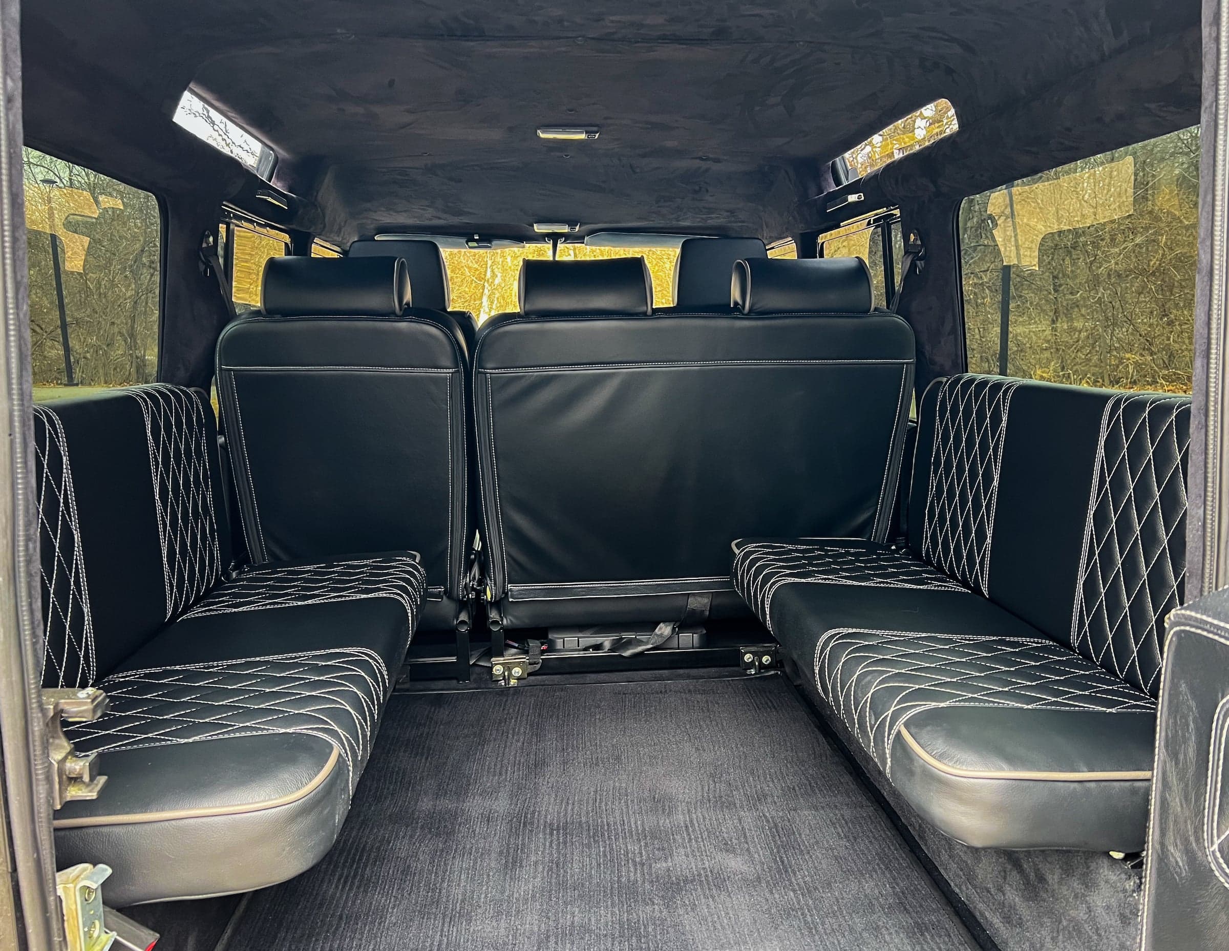 Interior Shot: Luxurious Rear Seating Interior view of a luxury Land Rover Defender with black quilted leather seating
