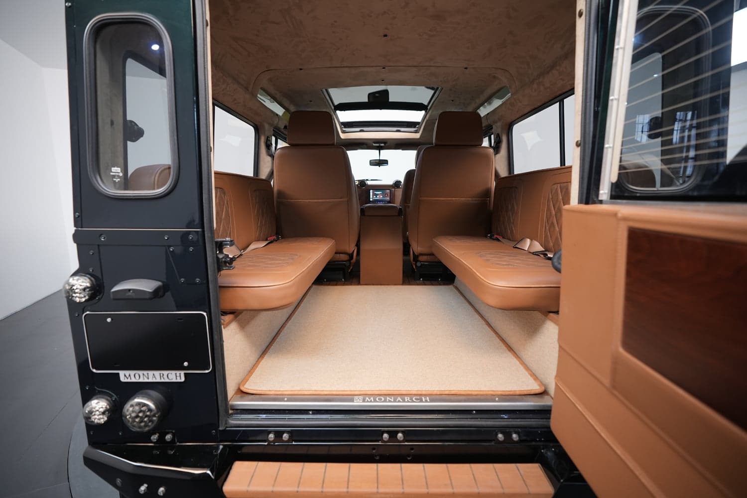 Interior Shot: Luxurious Cabin Space Interior view of a bespoke Land Rover Defender with brown leather seating and elegant details