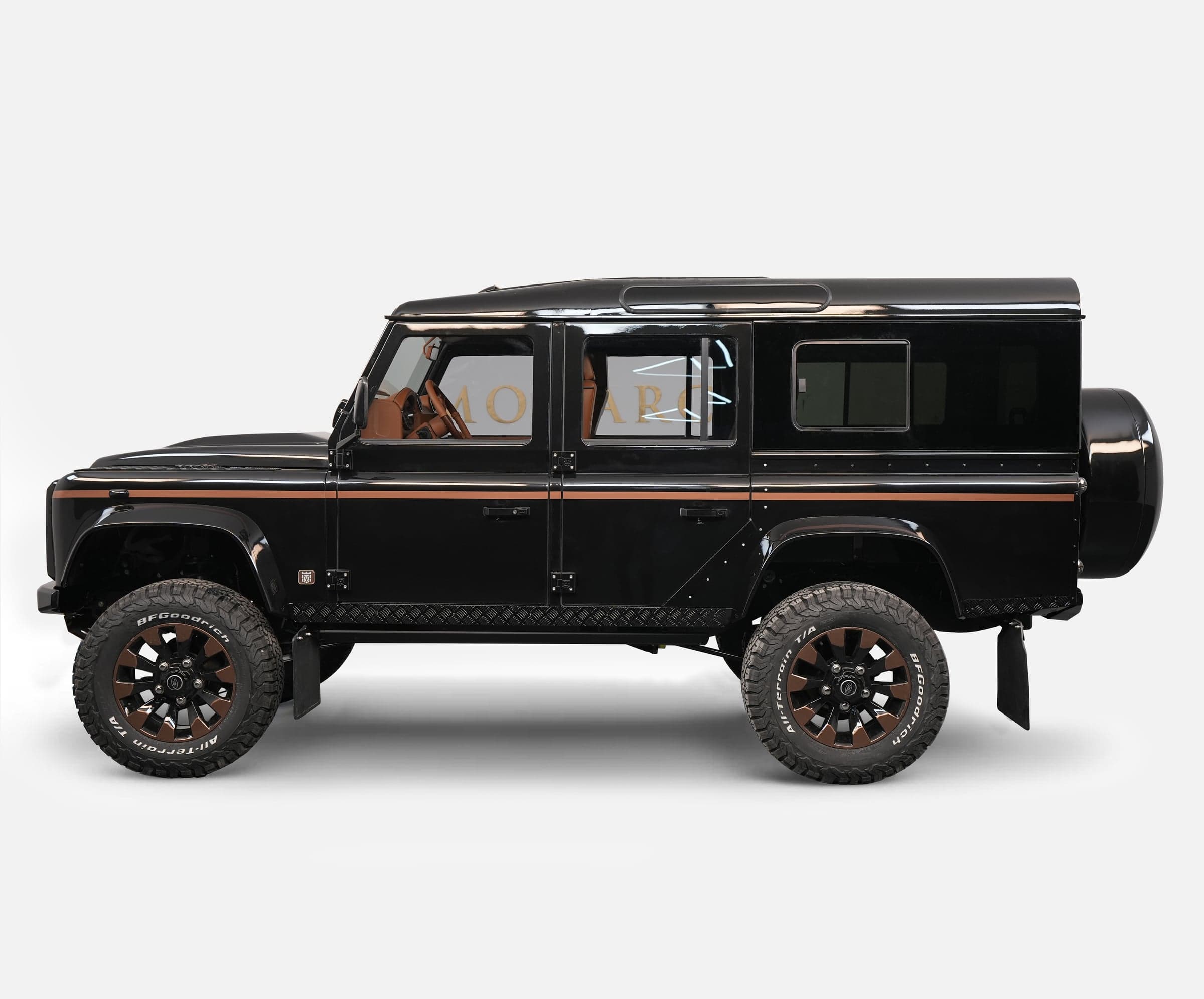 Side View: Bespoke Land Rover Defender Custom black Land Rover Defender with brown accents and premium wheels