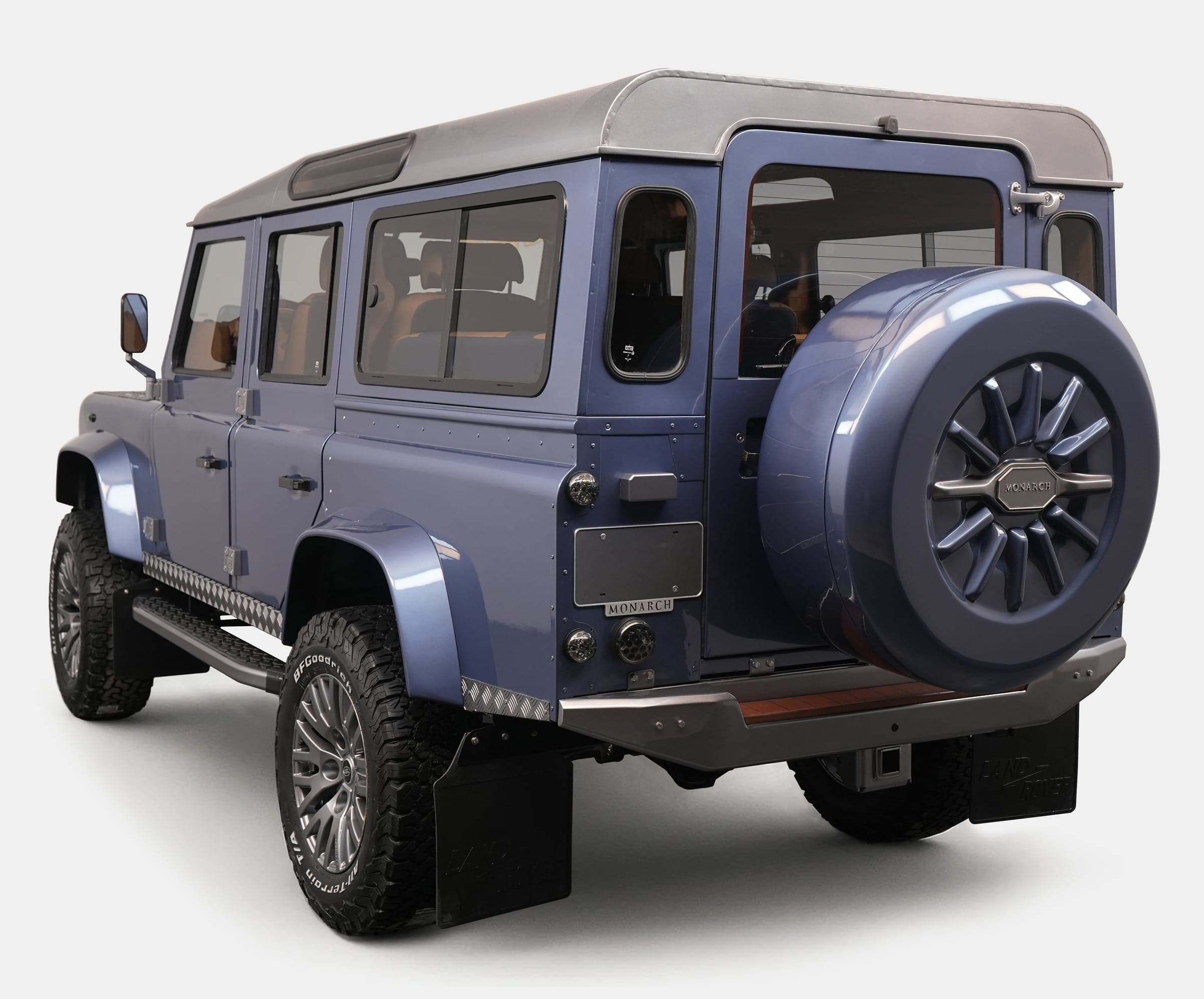 Rear View: Custom Land Rover Defender Luxury custom Land Rover Defender in blue with distinctive wheel design and premium features