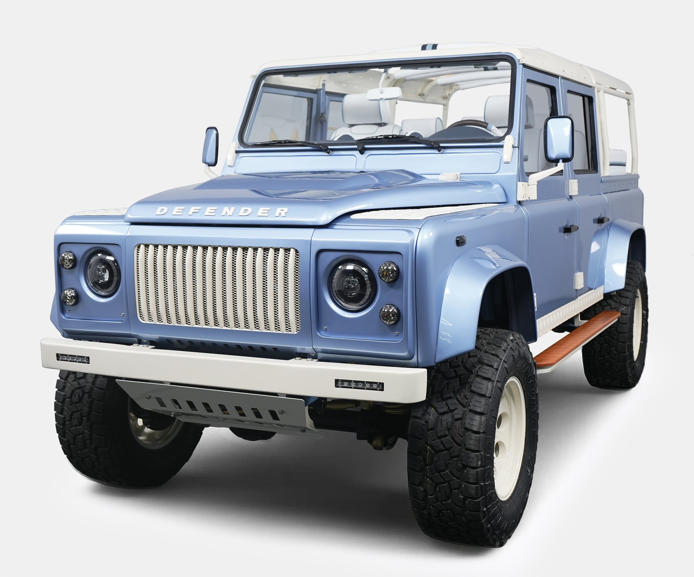 Custom Land Rover Defender in light blue with a white roof and rugged tires Custom Land Rover Defender in light blue with a white roof and rugged tires