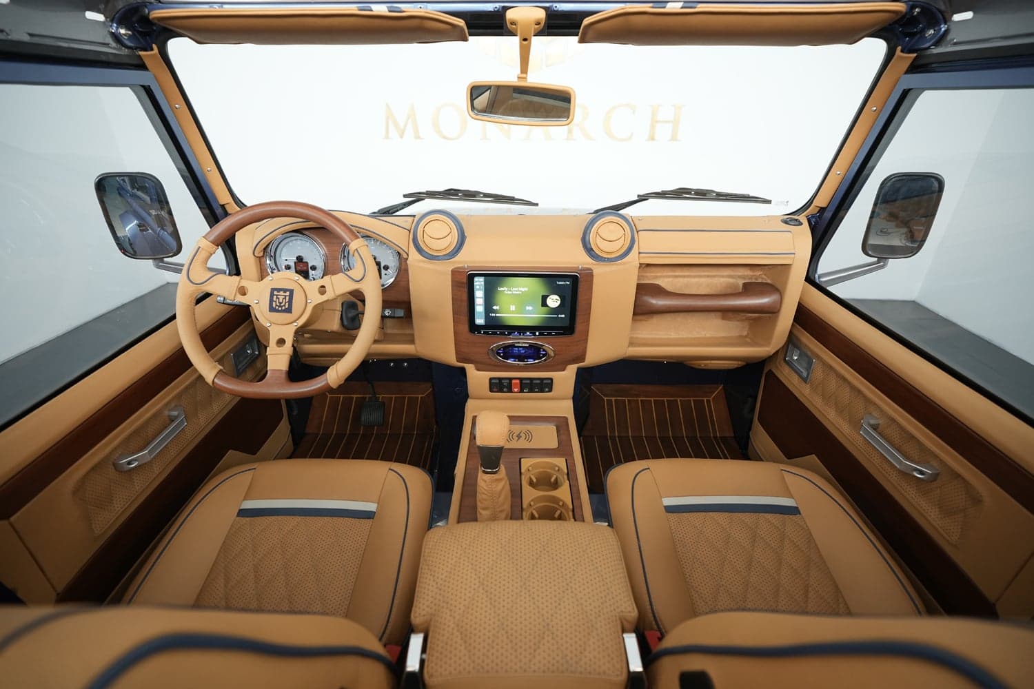 Interior Shot: Luxury Cabin Bespoke Land Rover Defender interior featuring premium tan leather and wood accents