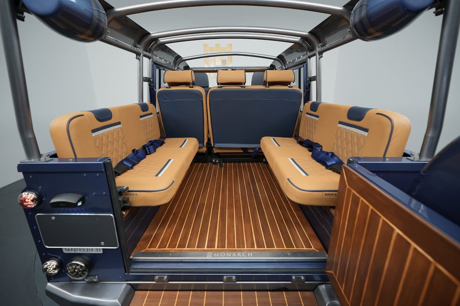 Interior Shot: Luxury Seating Interior view of a bespoke Land Rover Defender showcasing luxury tan seating and wooden flooring