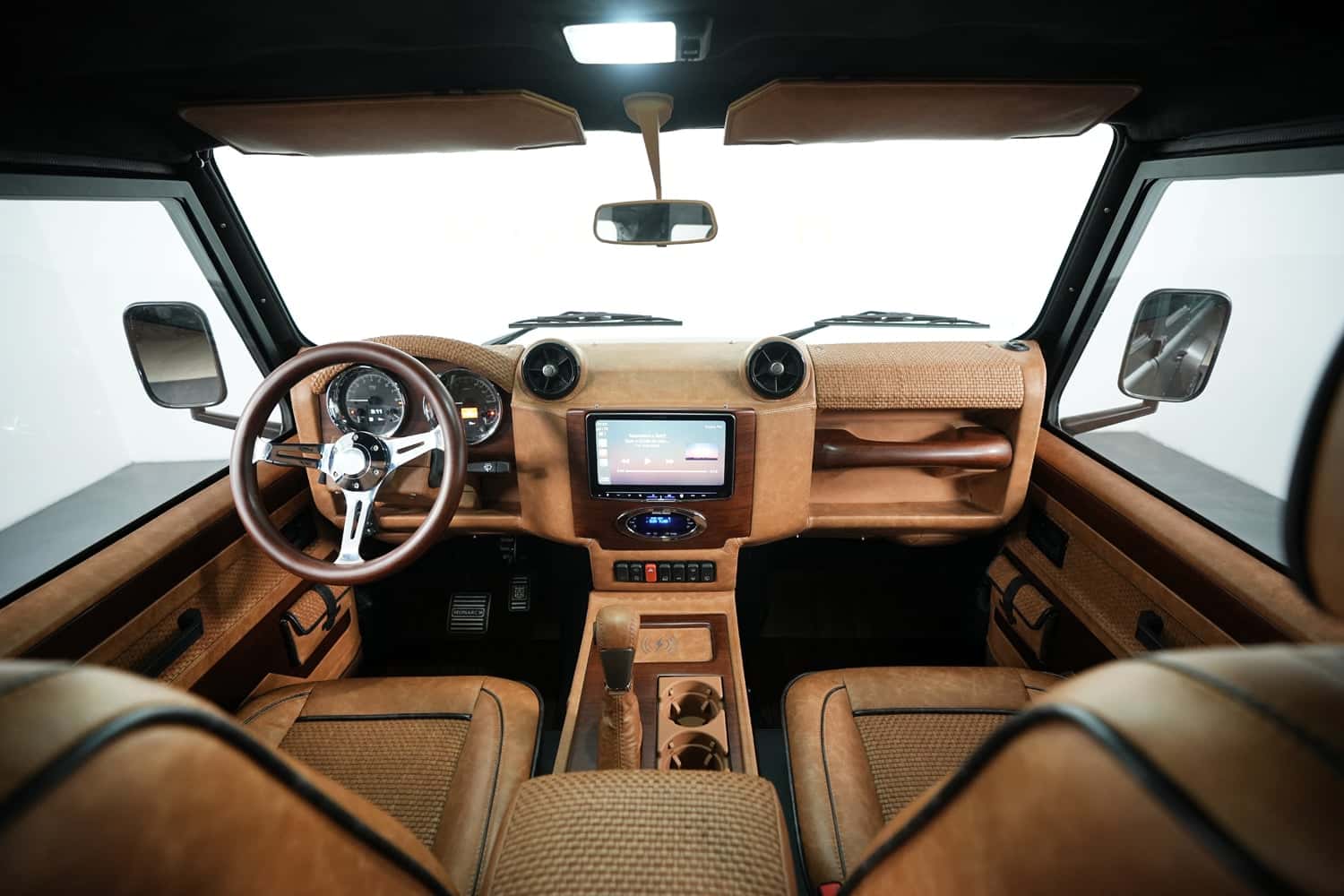 Interior view of a bespoke Land Rover Defender showcasing premium materials and modern technology