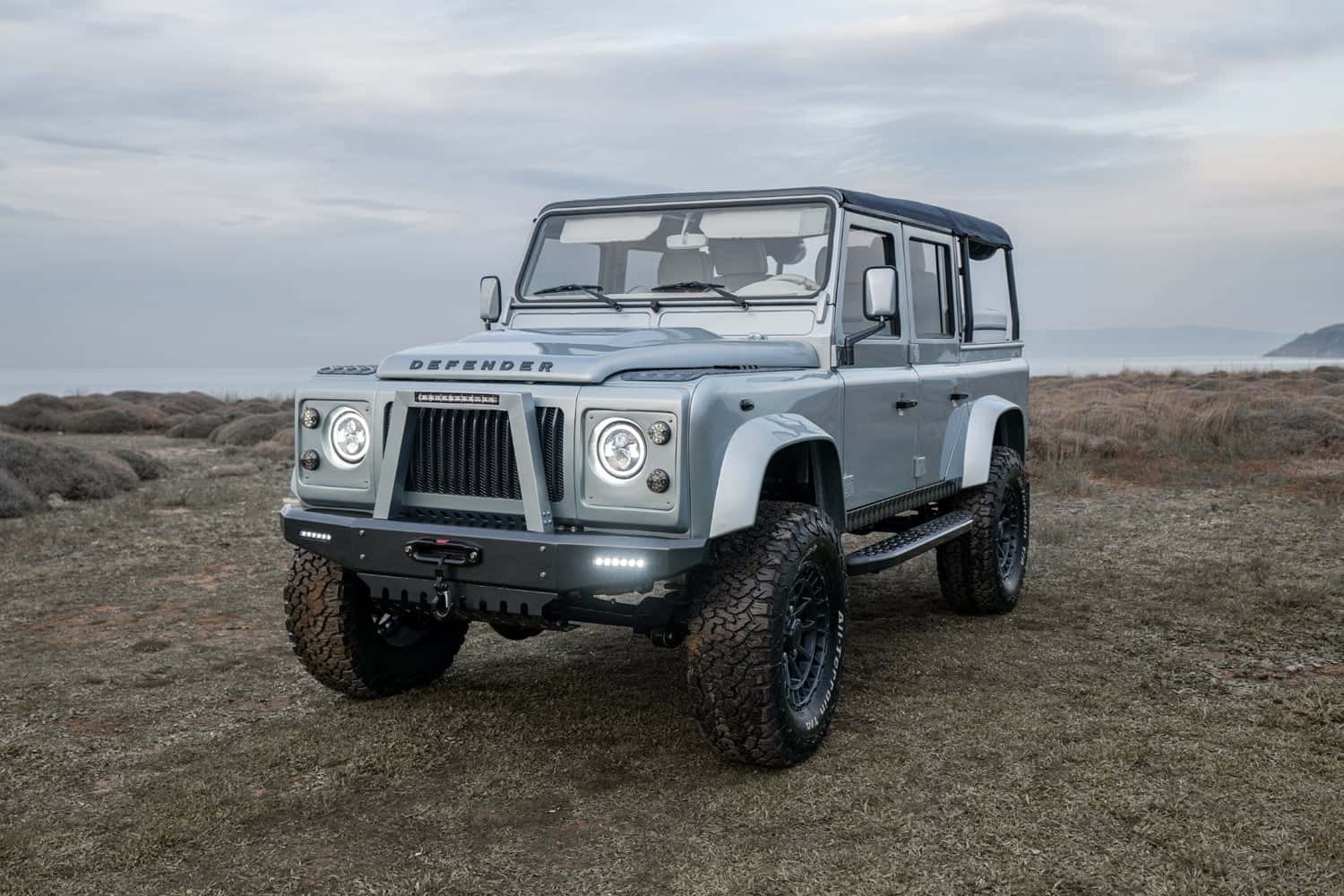 Front view of a luxury custom Land Rover Defender in a natural setting