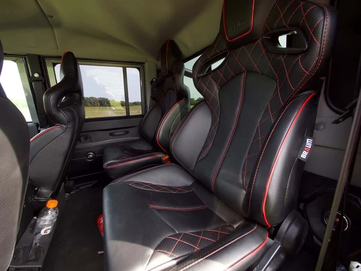 Custom leather seats with red stitching in a Land Rover Defender