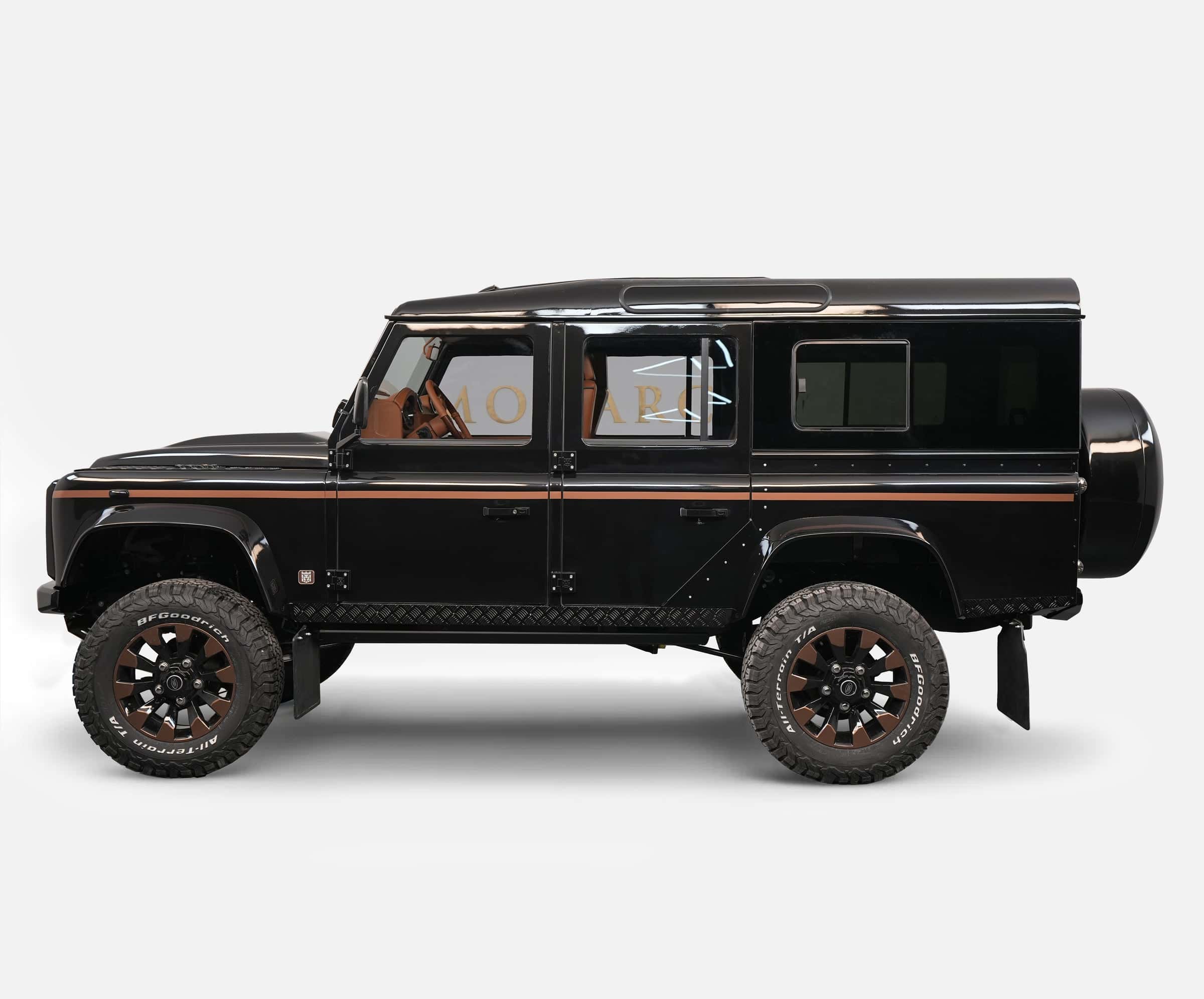 Custom black Land Rover Defender with brown accents and premium wheels