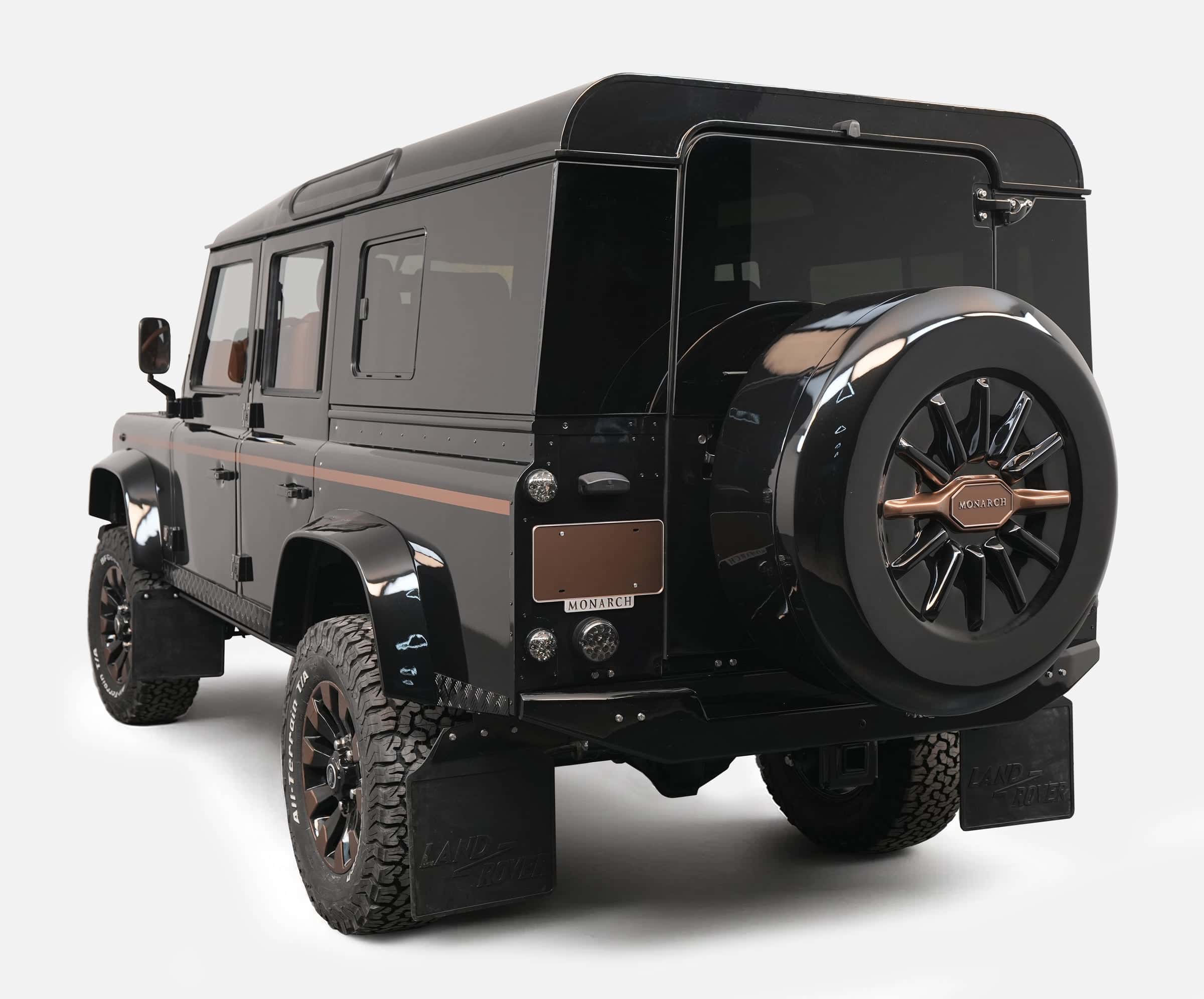 Customized black Land Rover Defender with unique styling and bronze accents