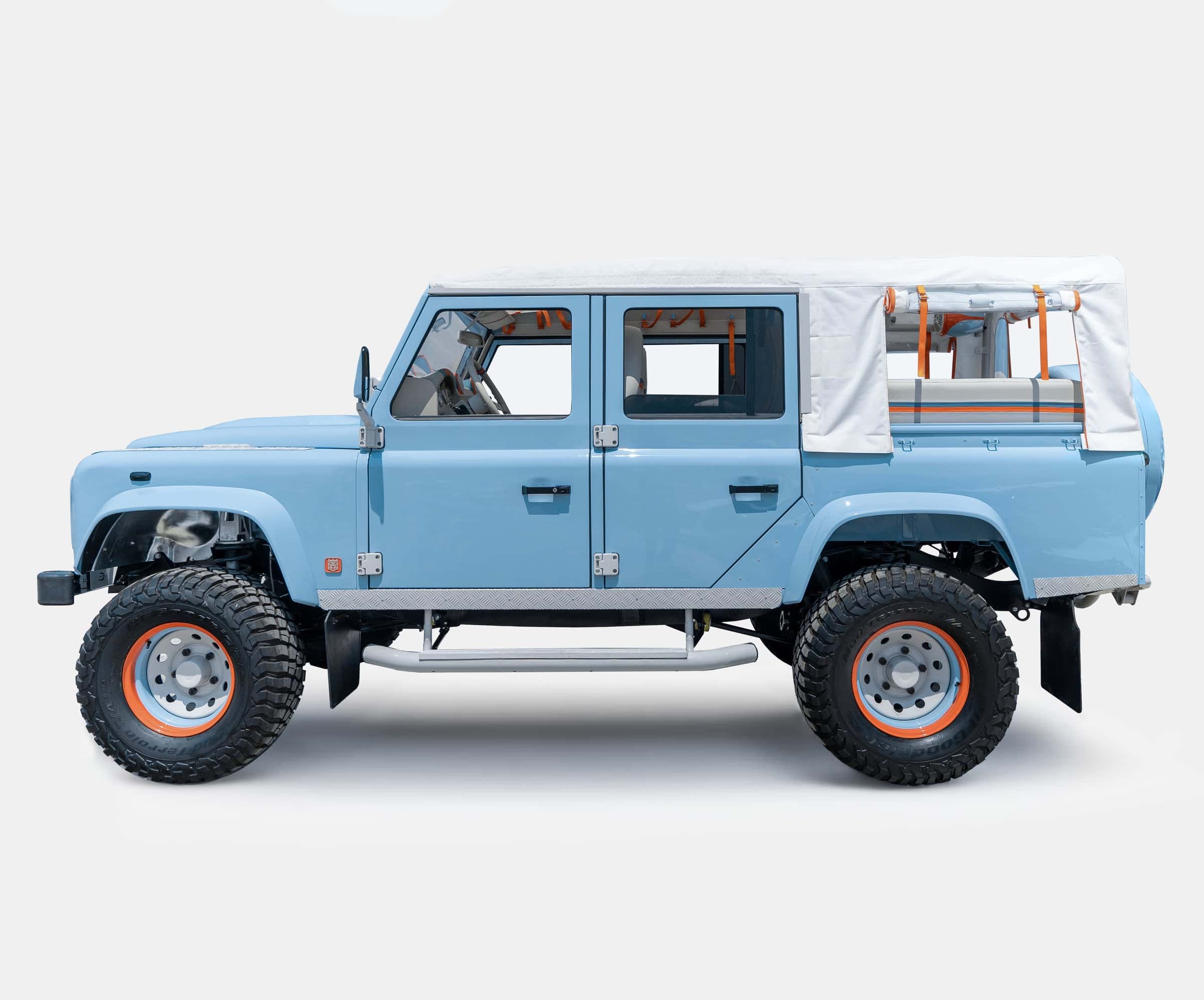 Custom Land Rover Defender in light blue with a canvas top and off-road tires