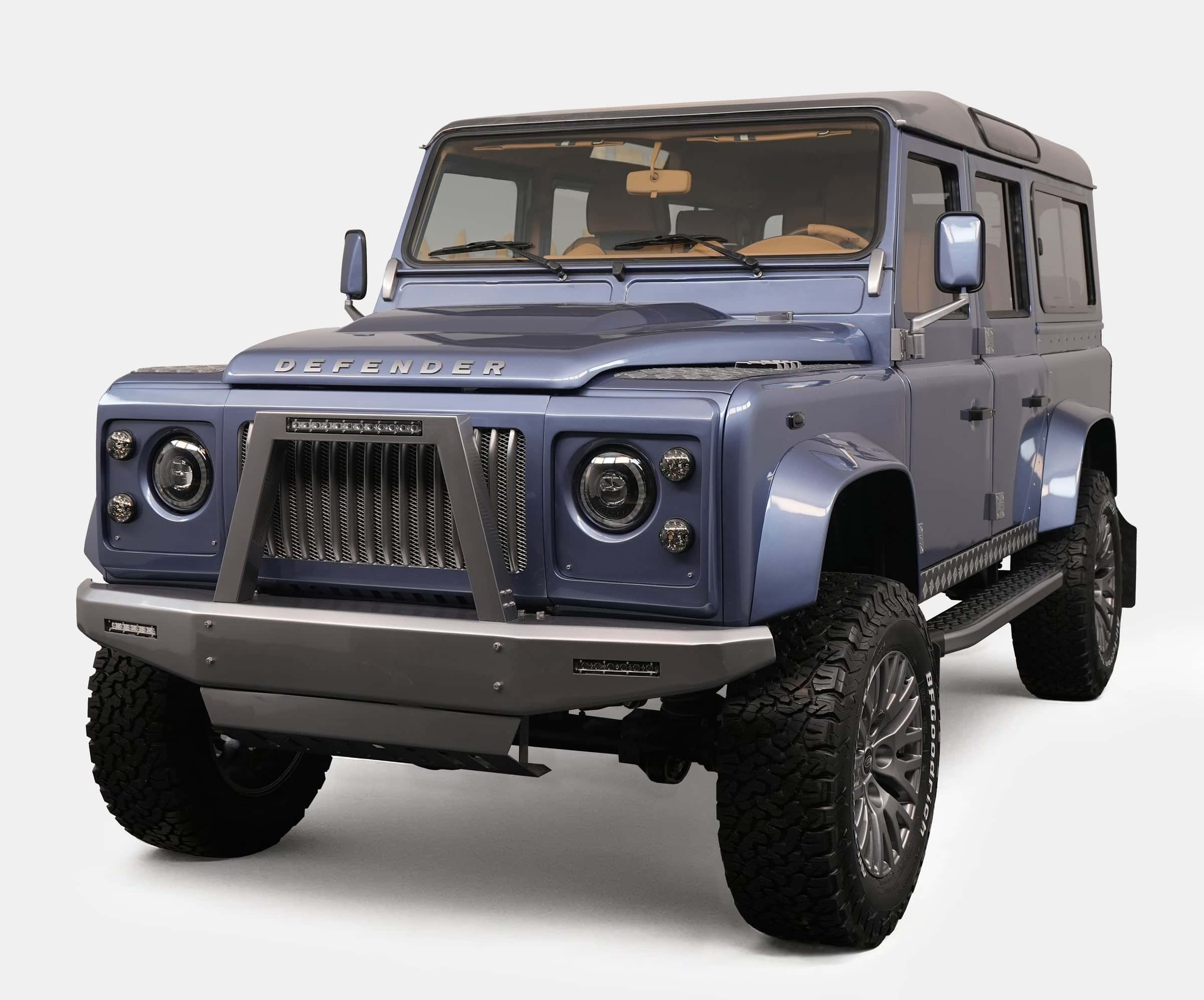 Bespoke Land Rover Defender in a sleek blue finish with rugged tires and modern grille