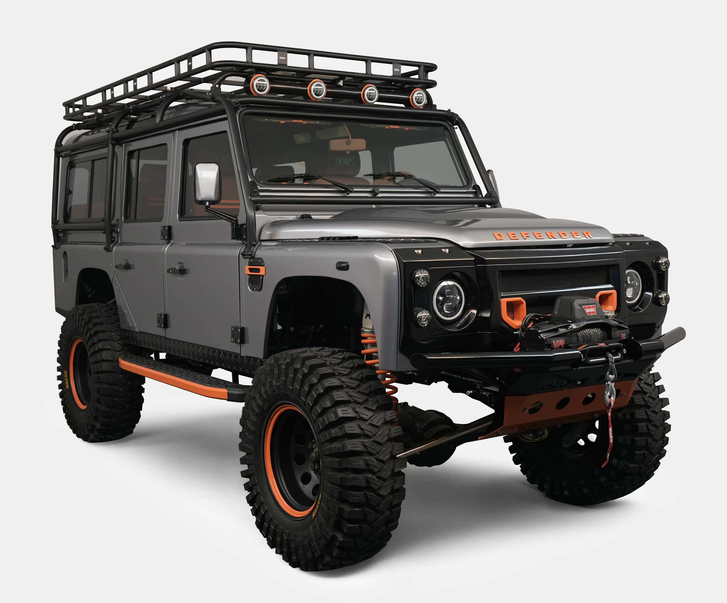 Custom Land Rover Defender in grey with orange accents and off-road tires