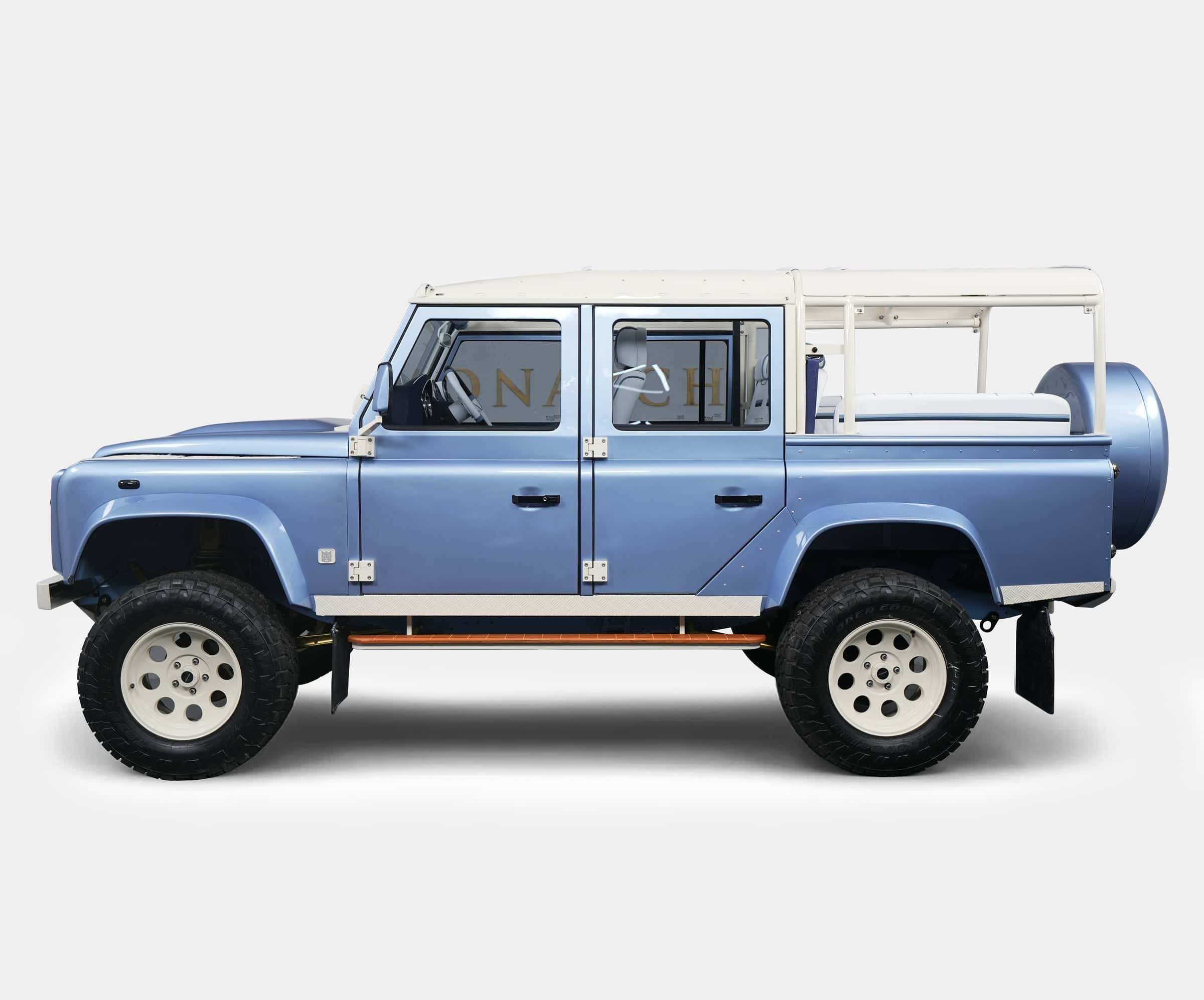 Side view of a luxury custom Land Rover Defender in blue with white accents