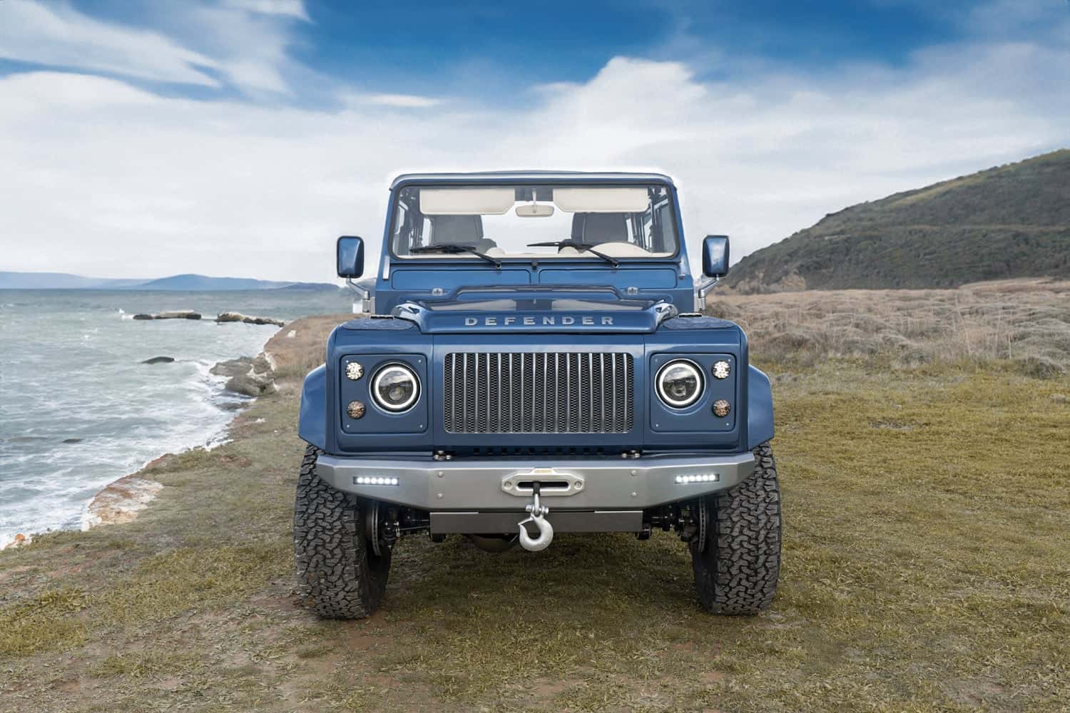 Bespoke Land Rover Defender parked by the coast