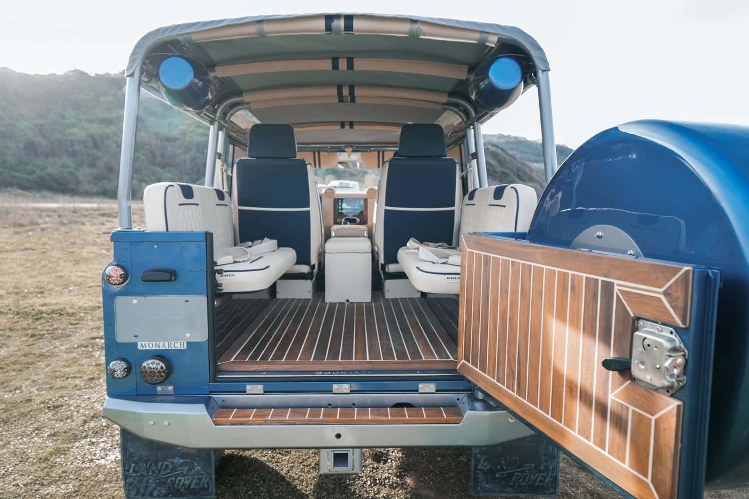 Interior view of a bespoke Land Rover Defender showcasing premium seating and wooden flooring