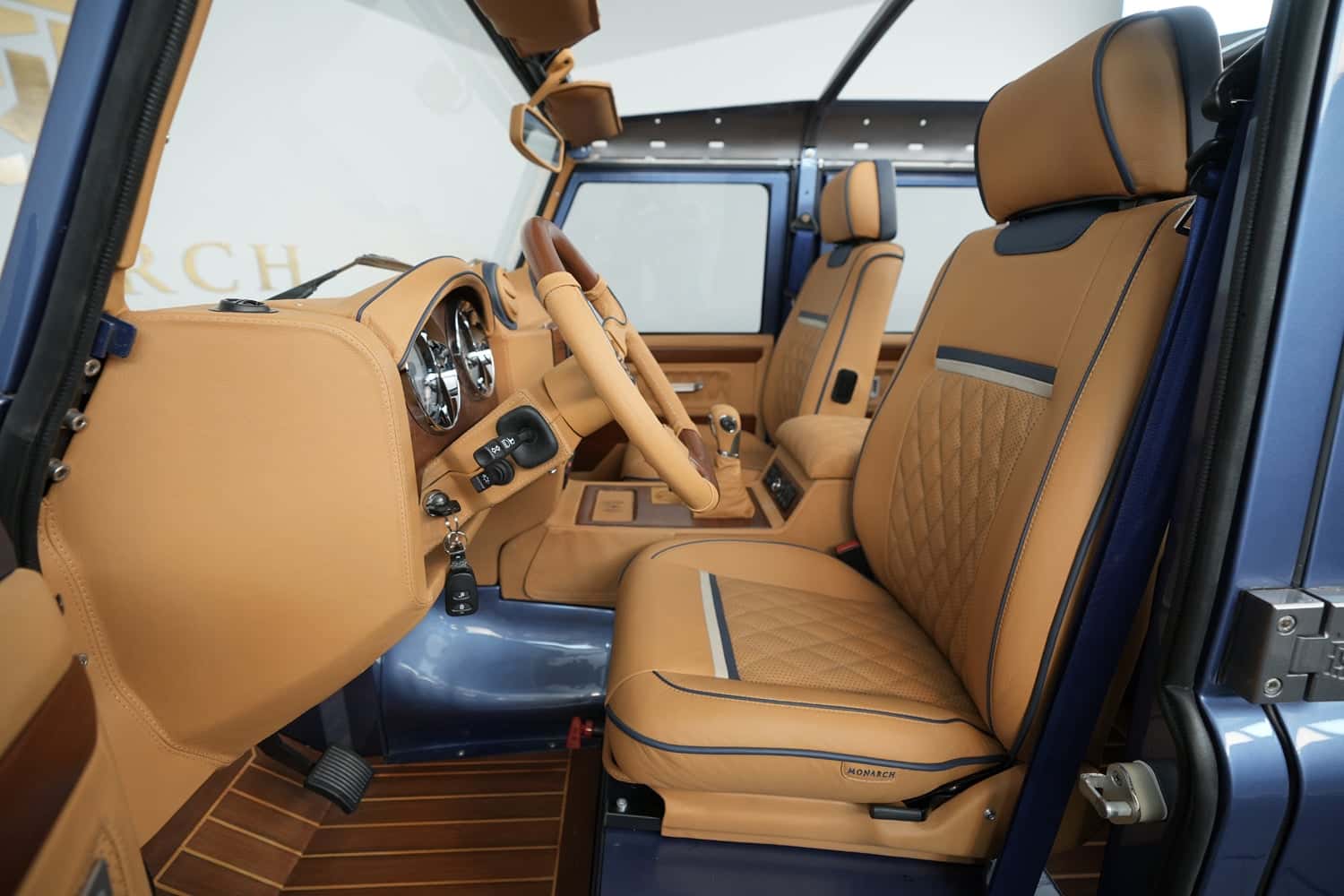 Bespoke Land Rover Defender interior featuring tan leather upholstery and wooden accents