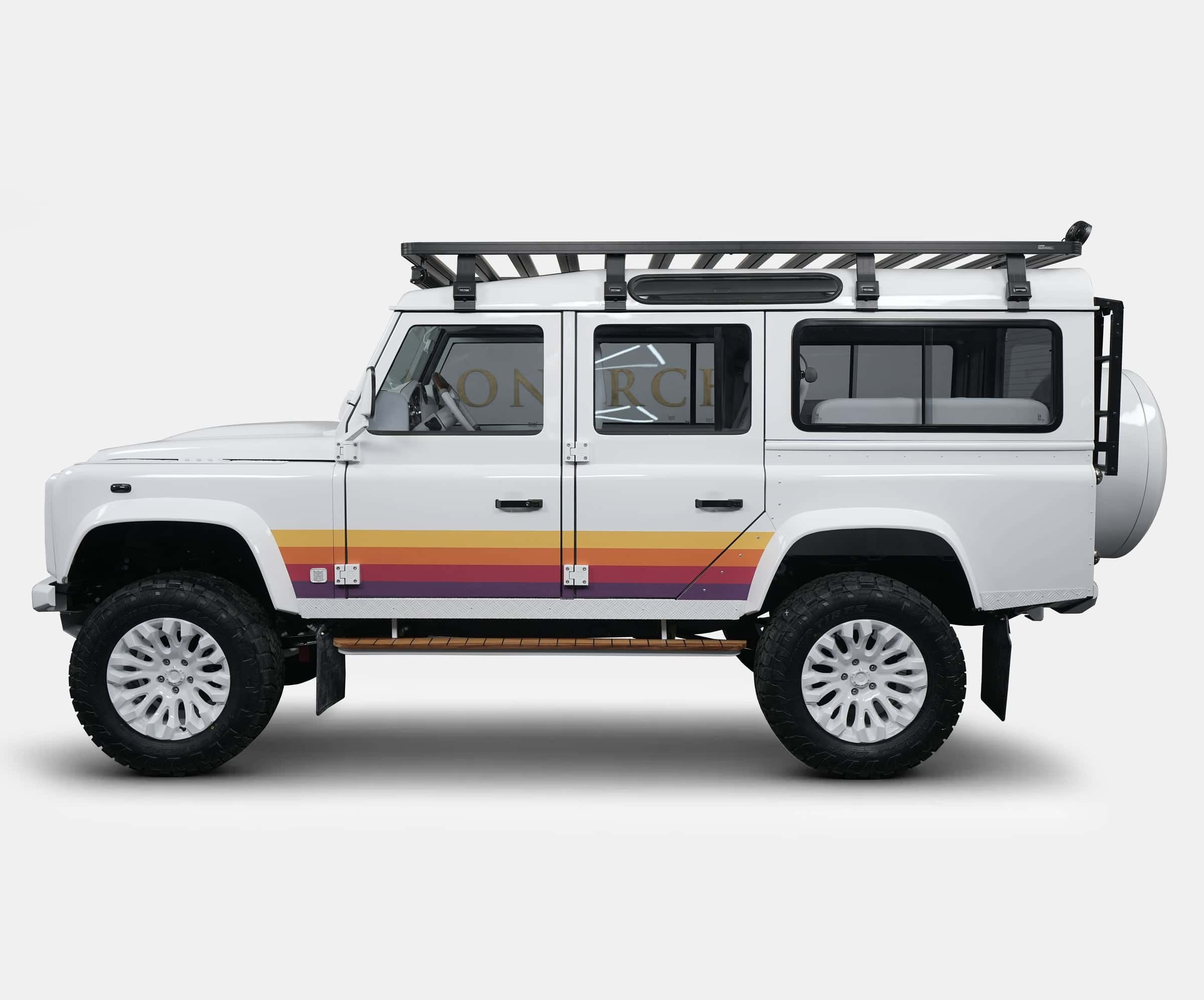 White custom Land Rover Defender with retro stripe design and roof rack