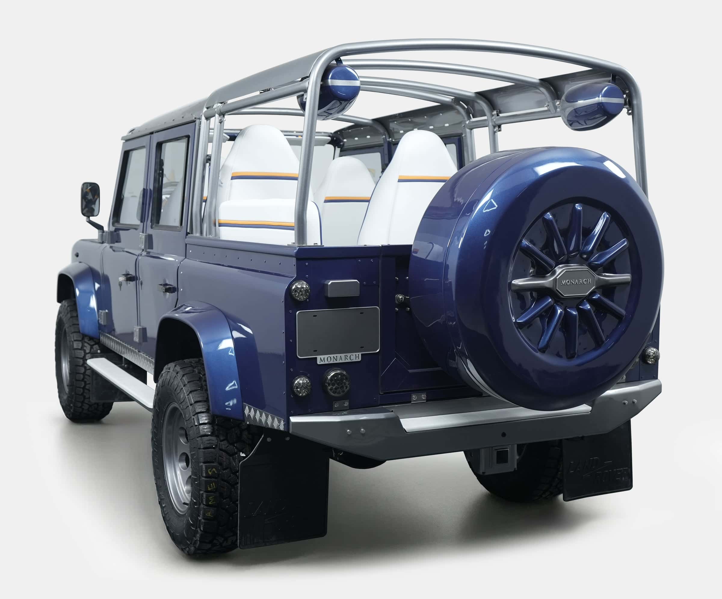 Rear view of a bespoke Land Rover Defender with a blue finish and premium seating