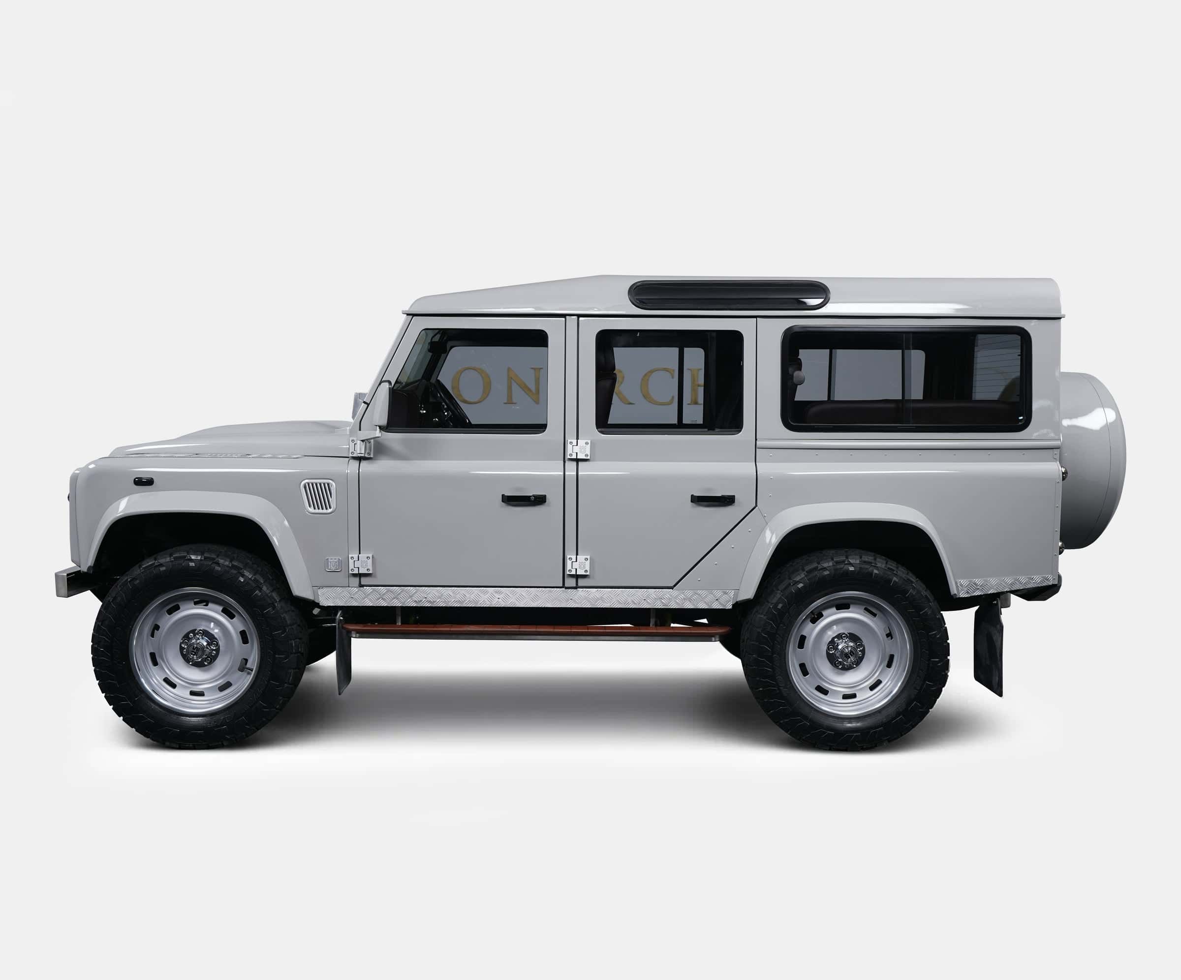 Side view of a bespoke Land Rover Defender in a sleek gray finish with off-road tires