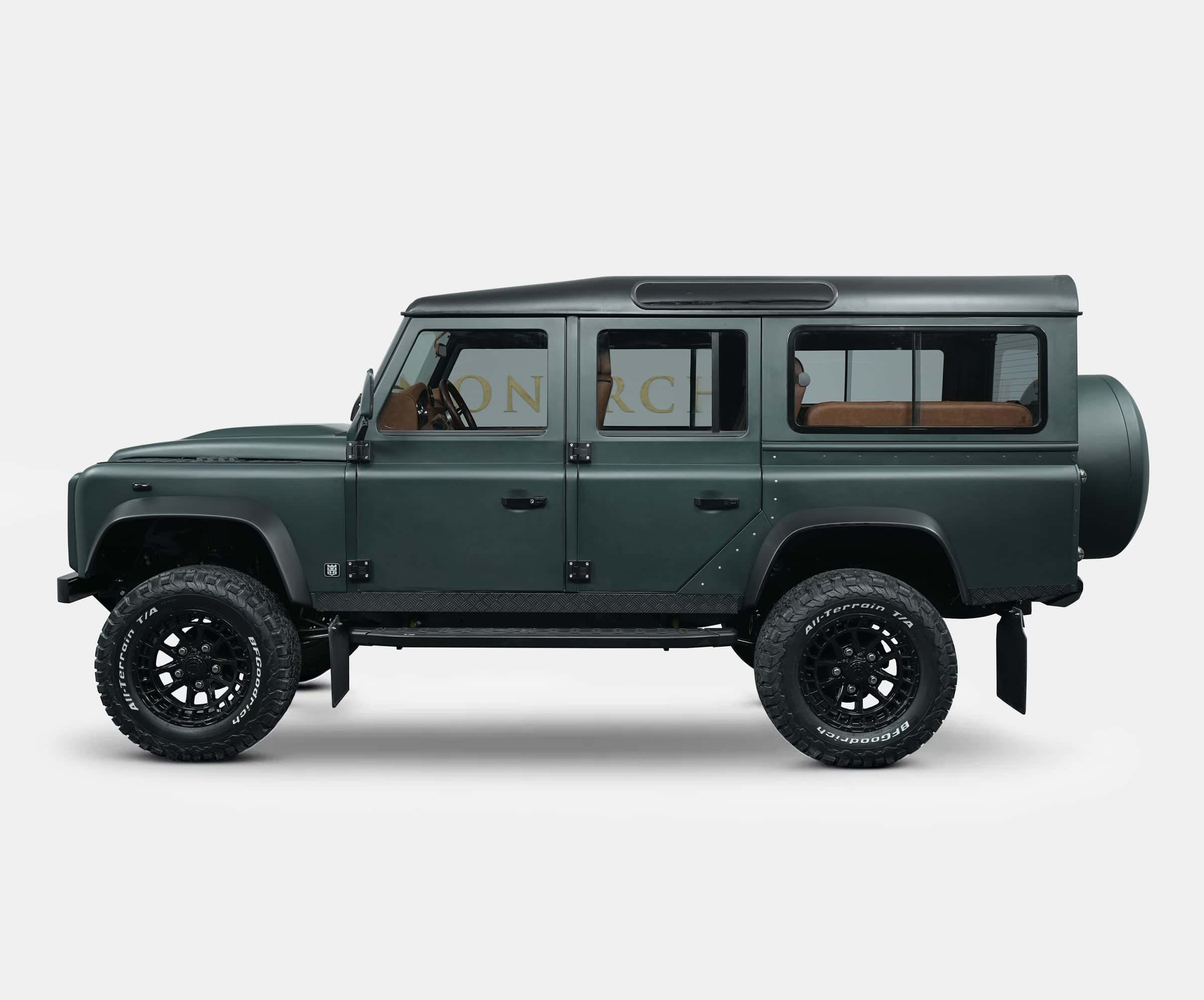 Custom Land Rover Defender in dark green with off-road tires