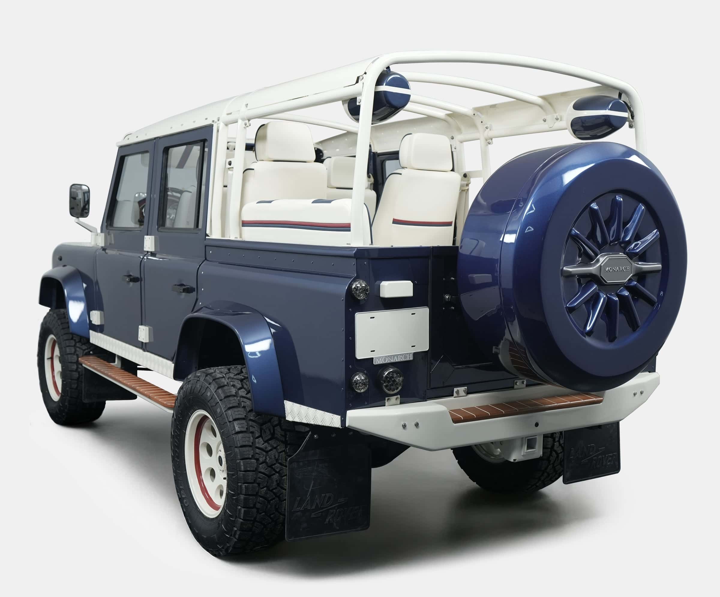 Custom Land Rover Defender in navy blue with white interior and off-road tires