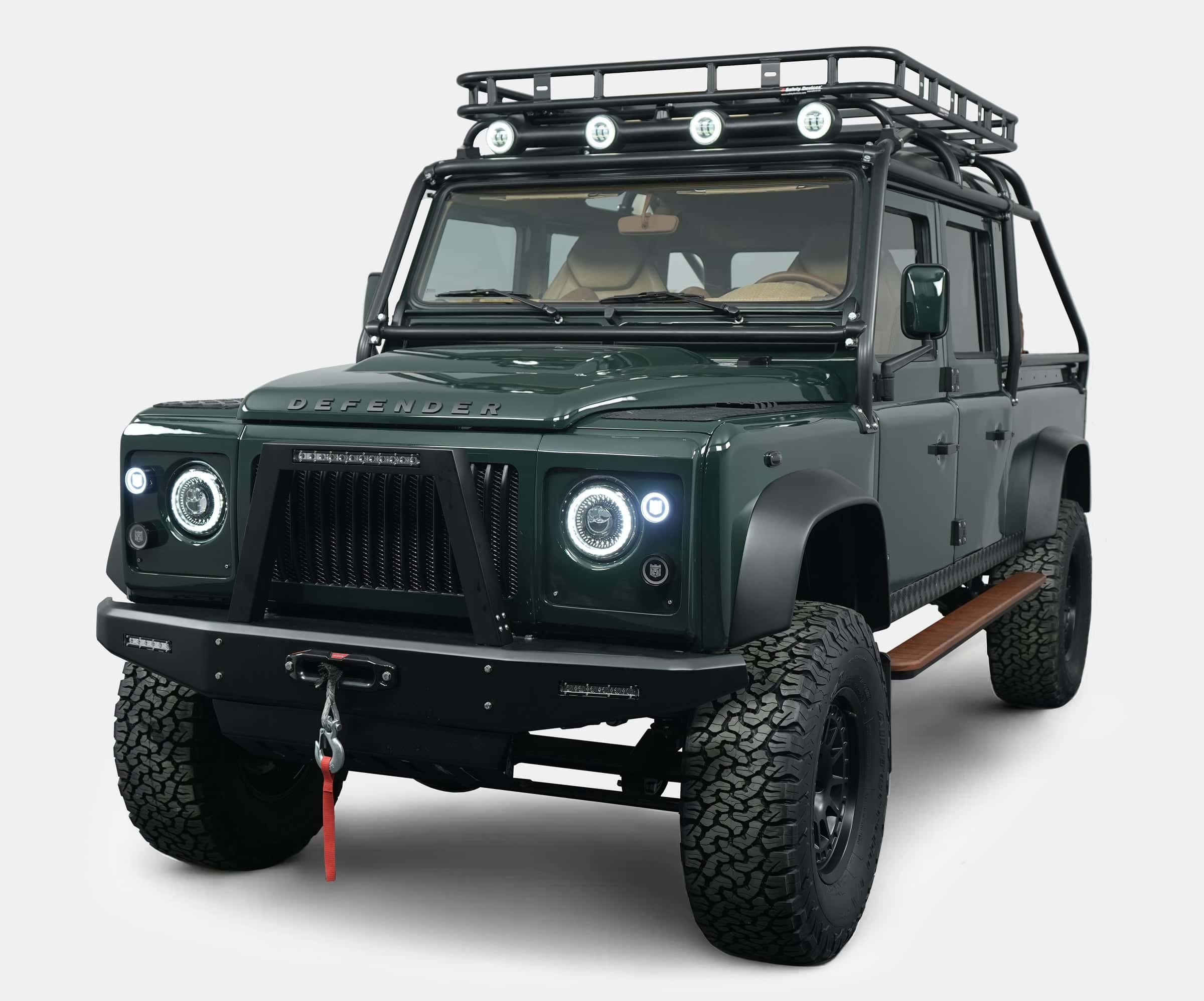 Custom Land Rover Defender in dark green with off-road modifications