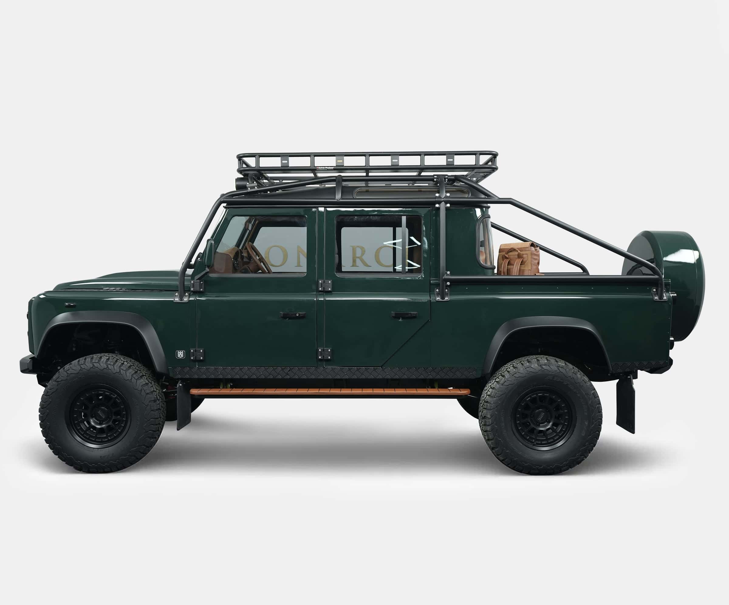 Side profile of a custom Land Rover Defender in green with off-road features