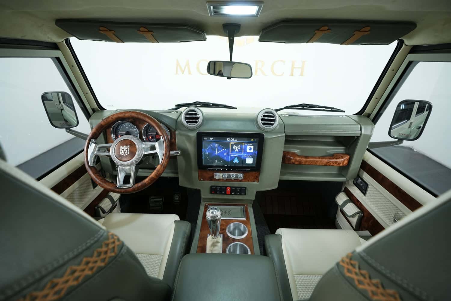 Bespoke Land Rover Defender interior featuring wood accents and modern tech