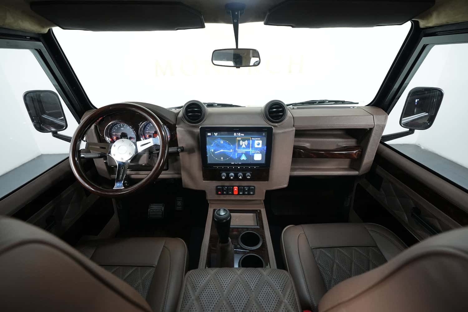 Interior view of a luxury custom Land Rover Defender showcasing a stylish dashboard and seating