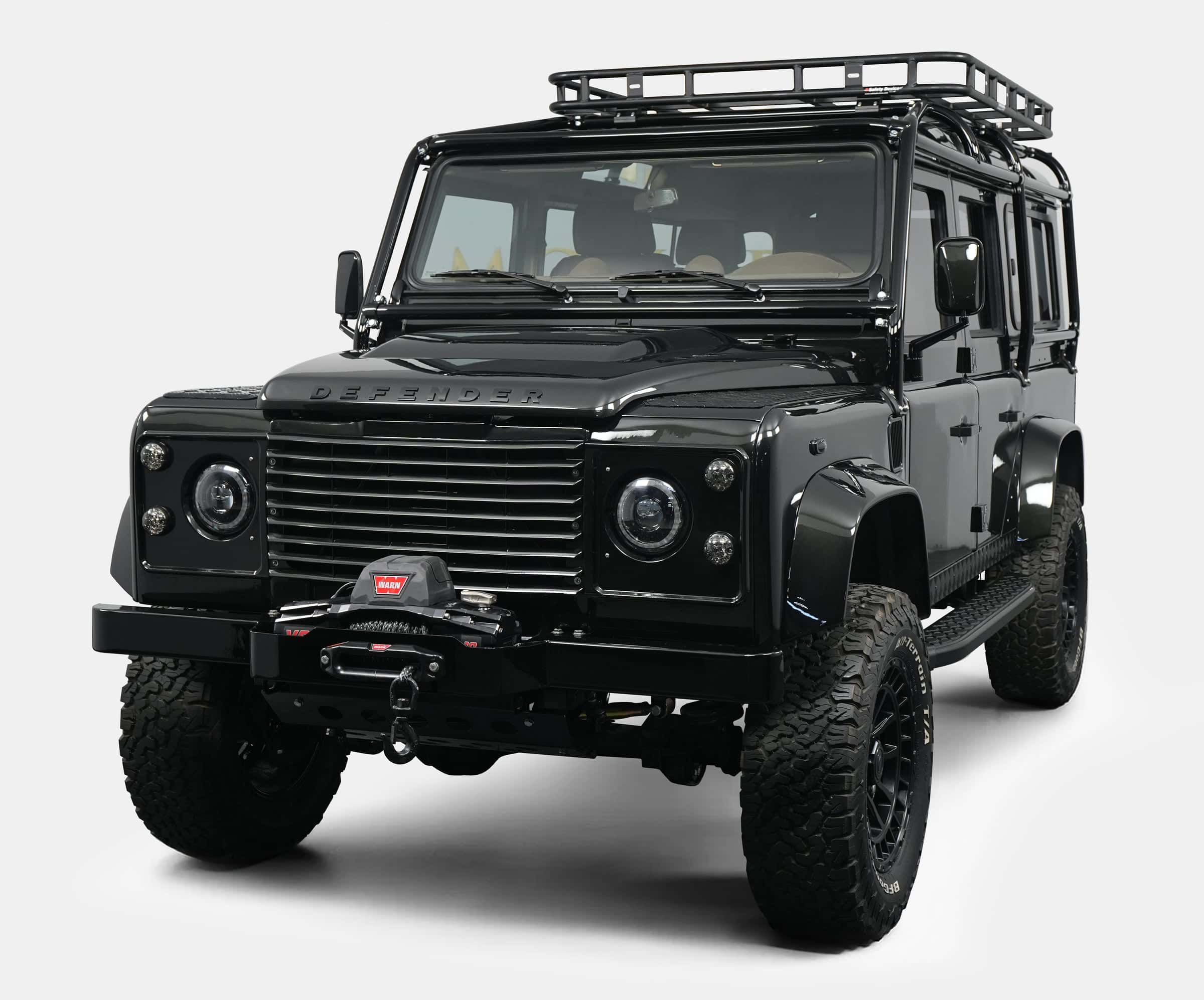 Front view of a luxury custom Land Rover Defender with a black exterior and off-road features
