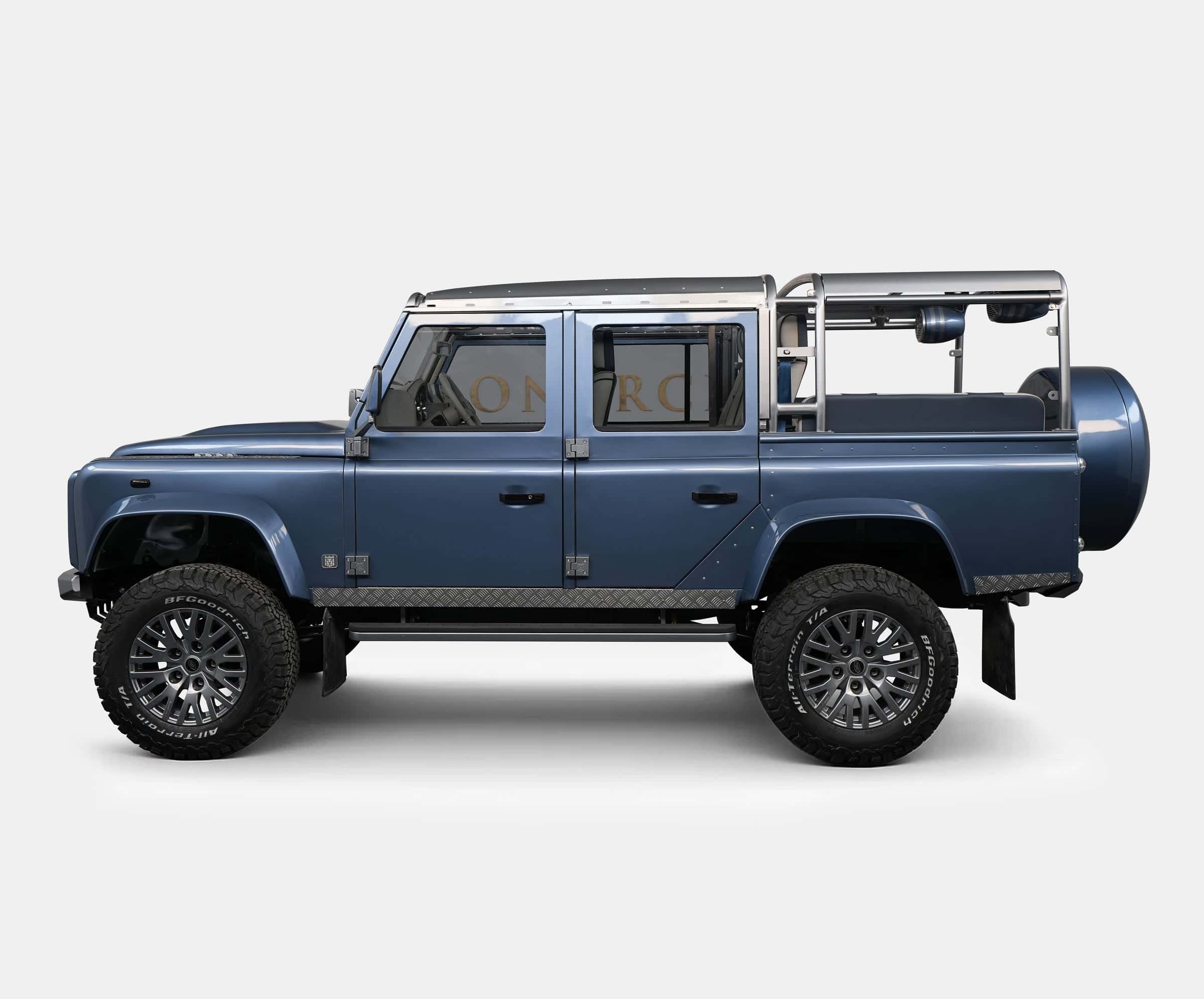 Bespoke Land Rover Defender in blue with rugged tires and stainless steel accents