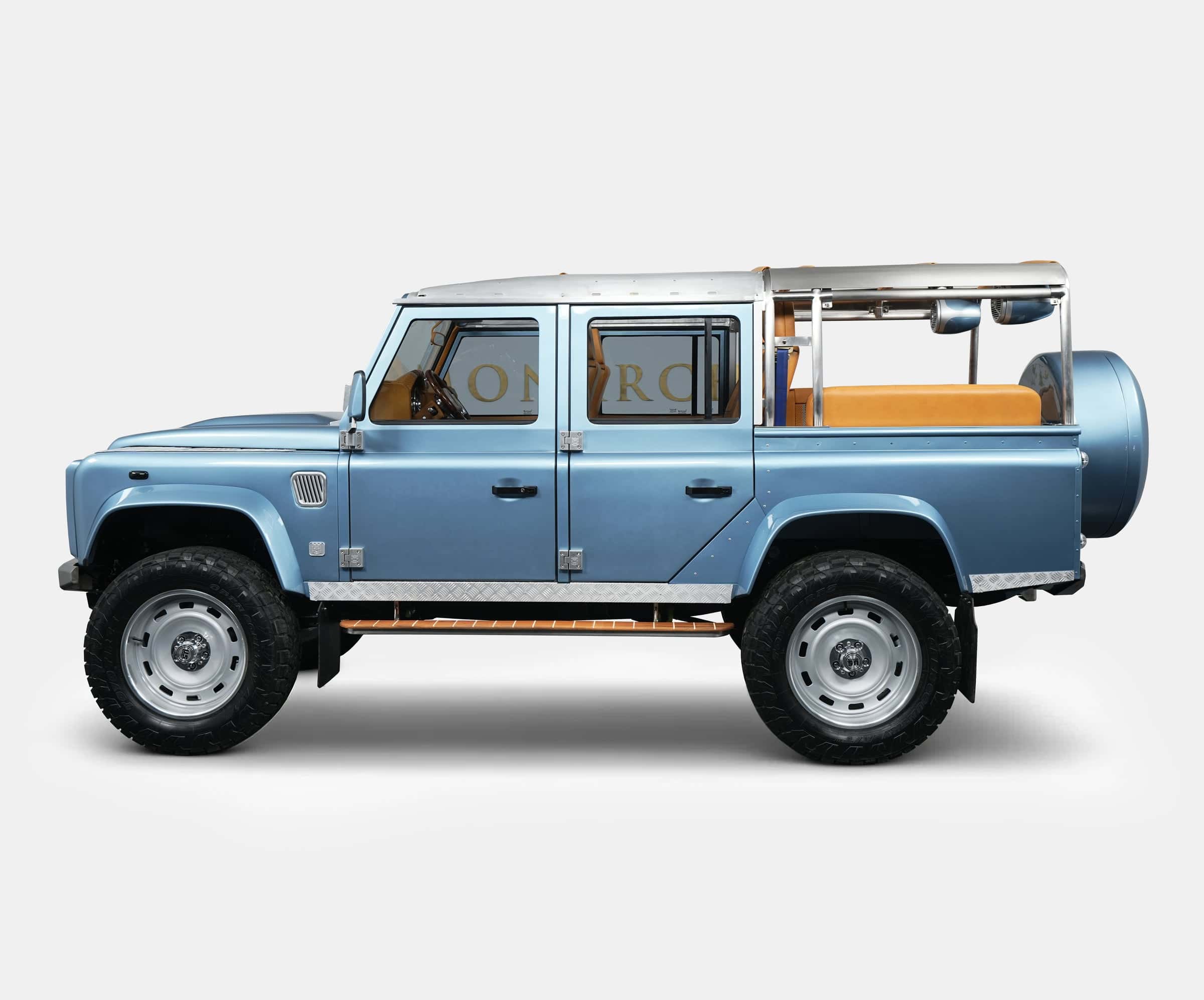 Custom blue Land Rover Defender with tan interior and chrome accents