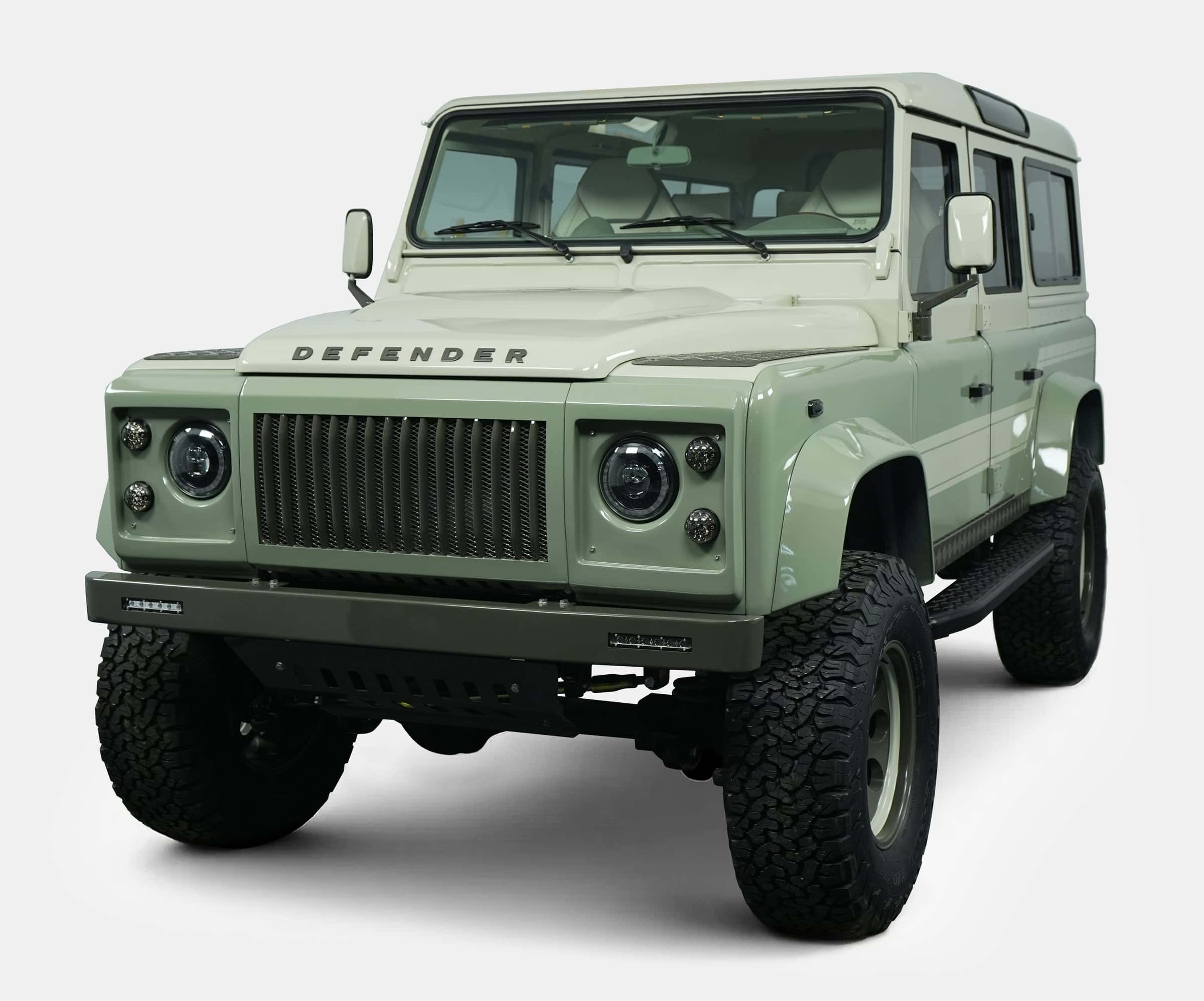 Custom Land Rover Defender in light green with rugged tires
