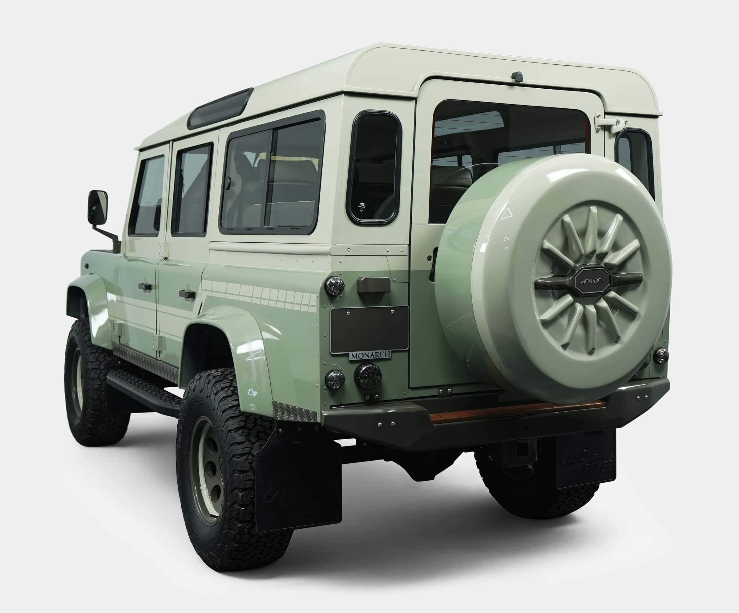Rear view of a bespoke Land Rover Defender in light green with custom features