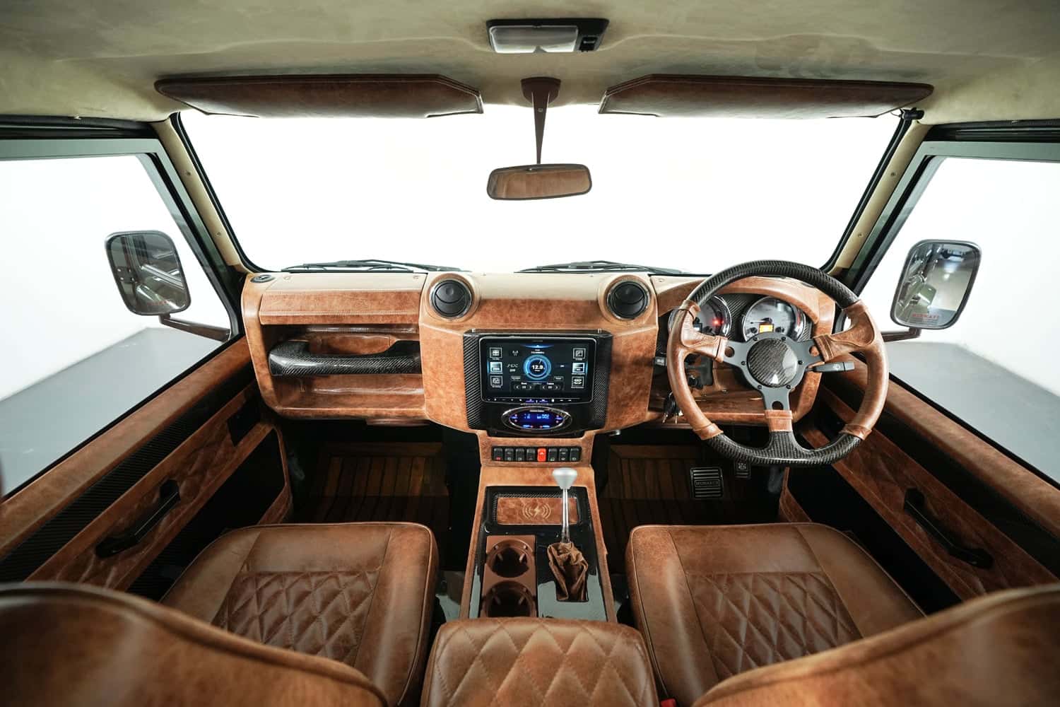 Bespoke Land Rover Defender interior featuring premium leather seats and advanced dashboard