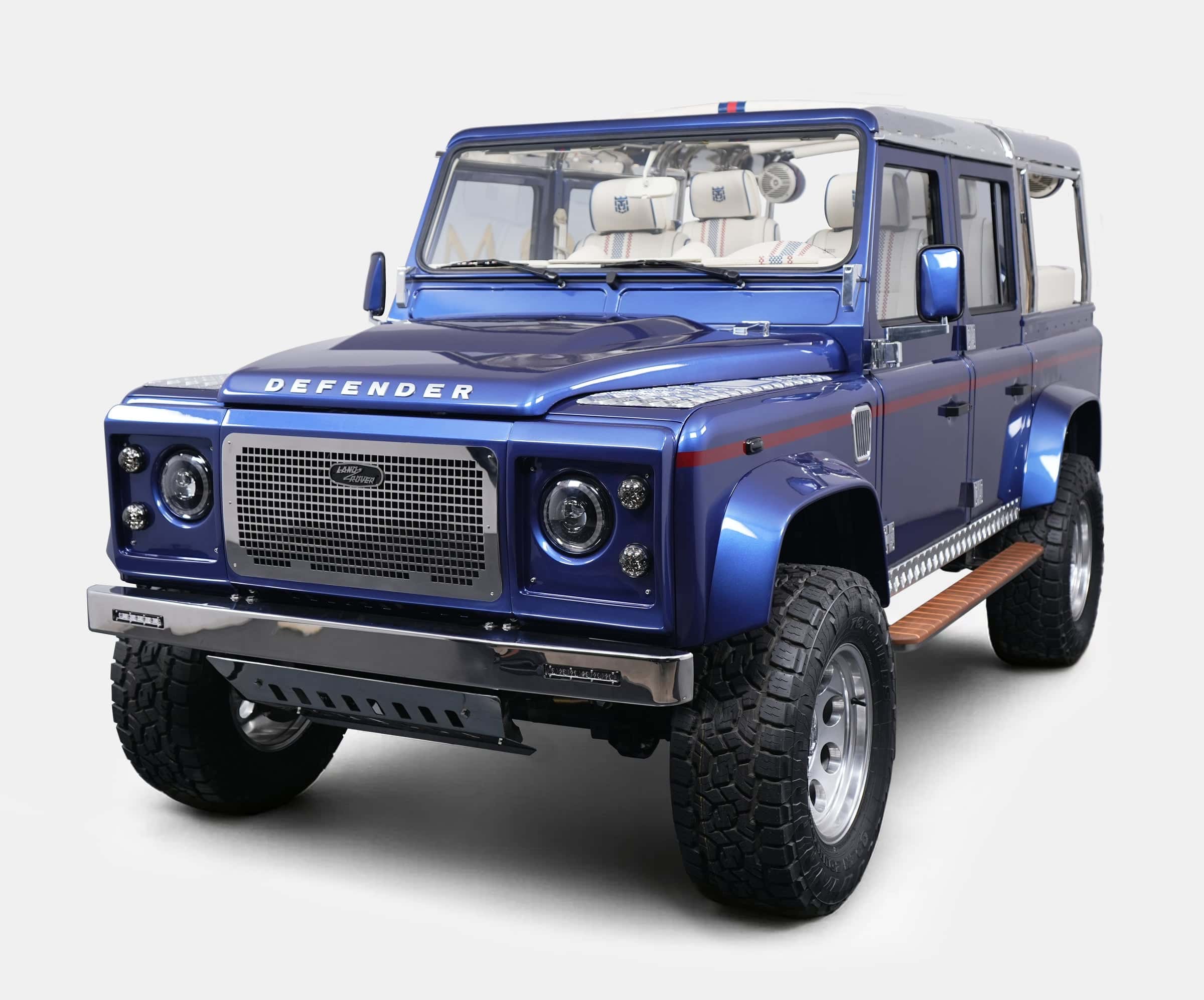 Custom blue Land Rover Defender with luxury details and off-road capabilities