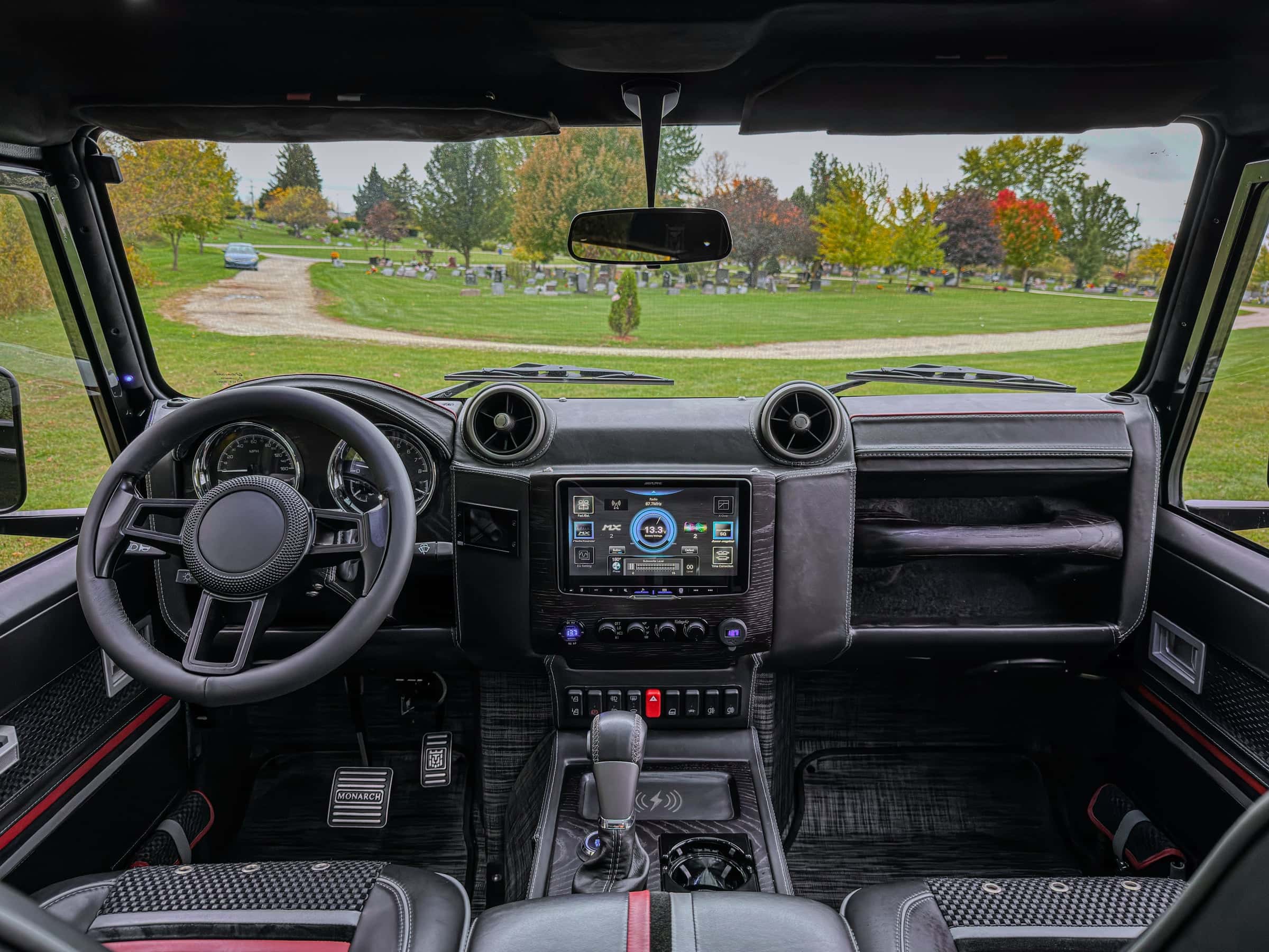 Interior view of a custom Land Rover Defender featuring premium materials and advanced technology